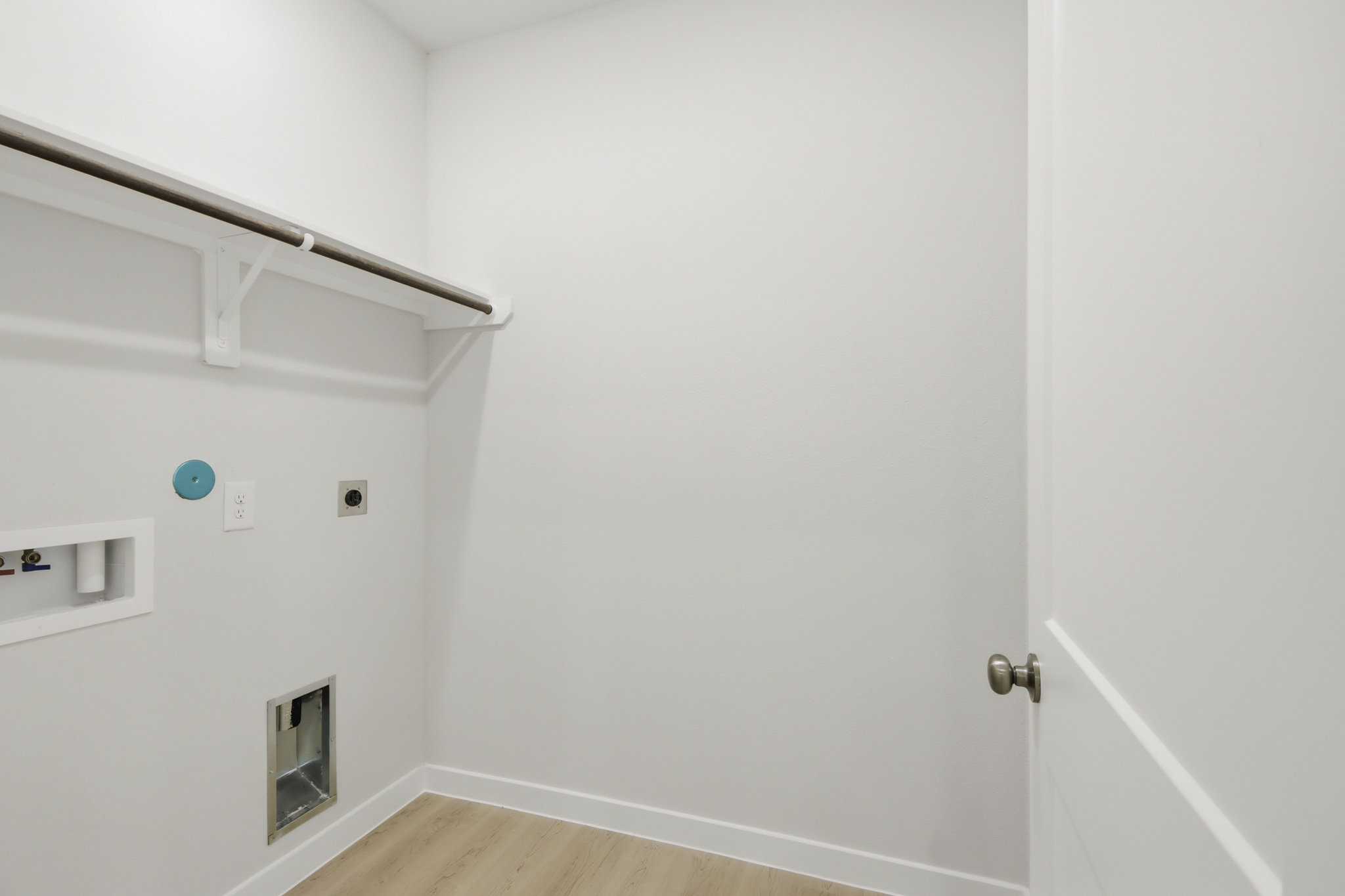 A white room with a white door.