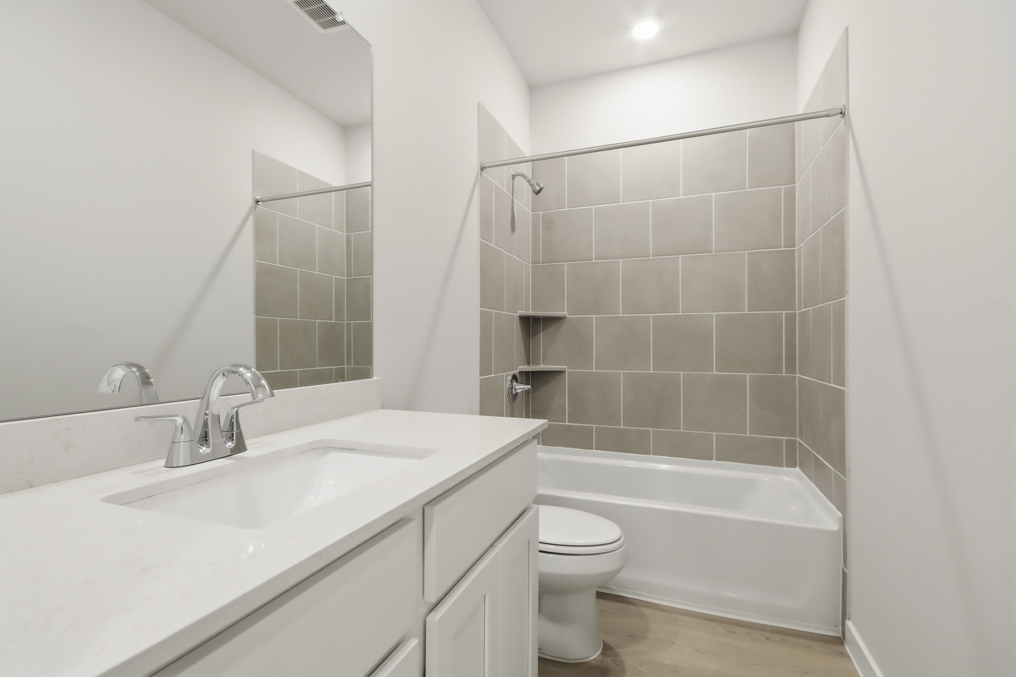 A bathroom with a tub sink and toilet.