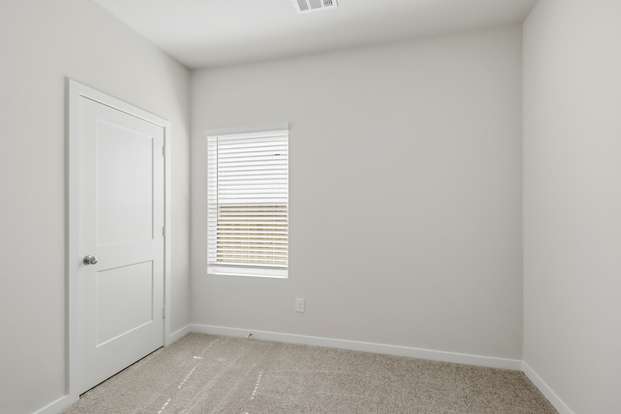 A room with a door and a window.