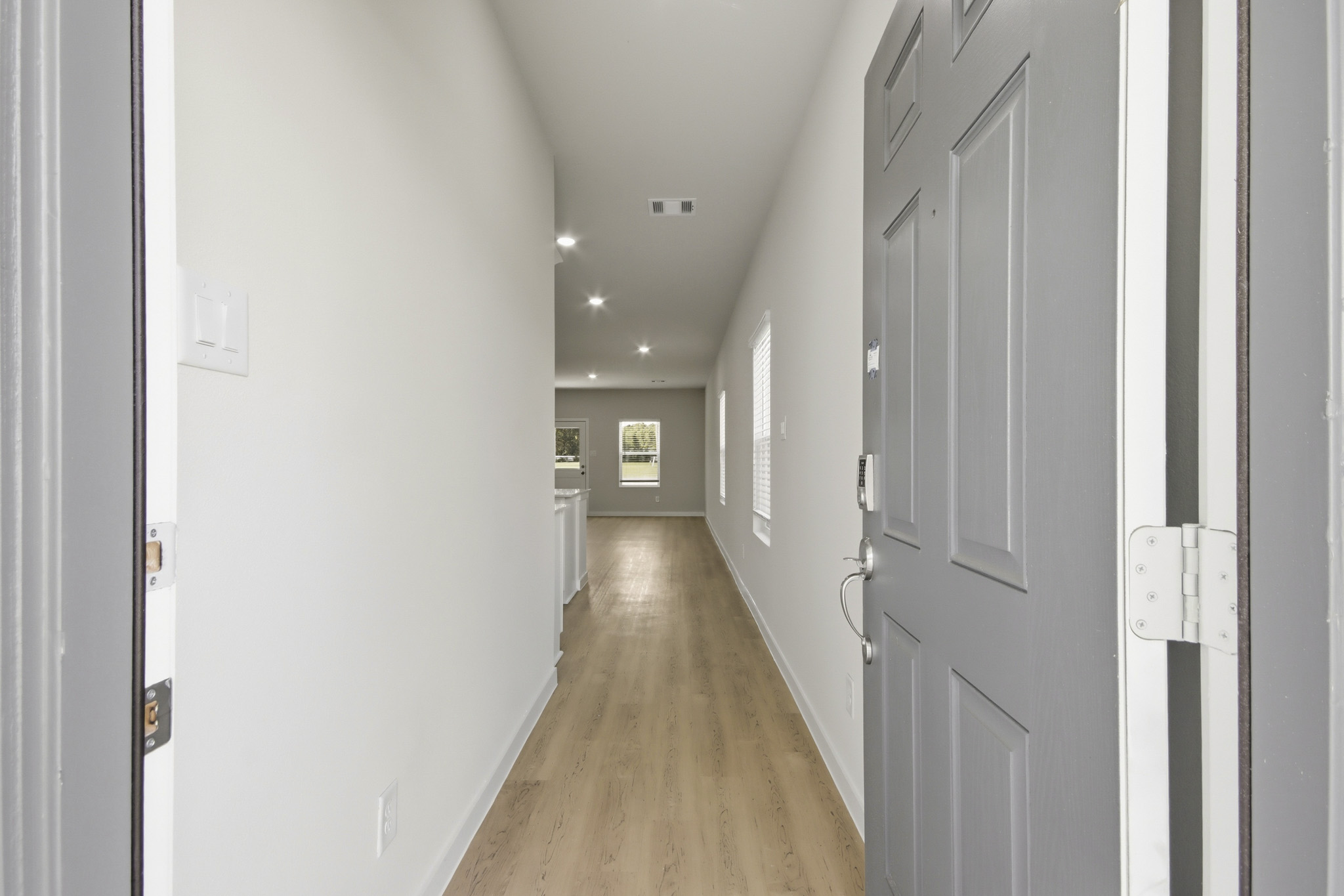A hallway with white doors.