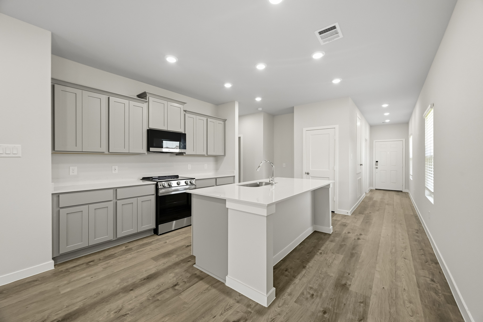 A kitchen with white cabinets.
