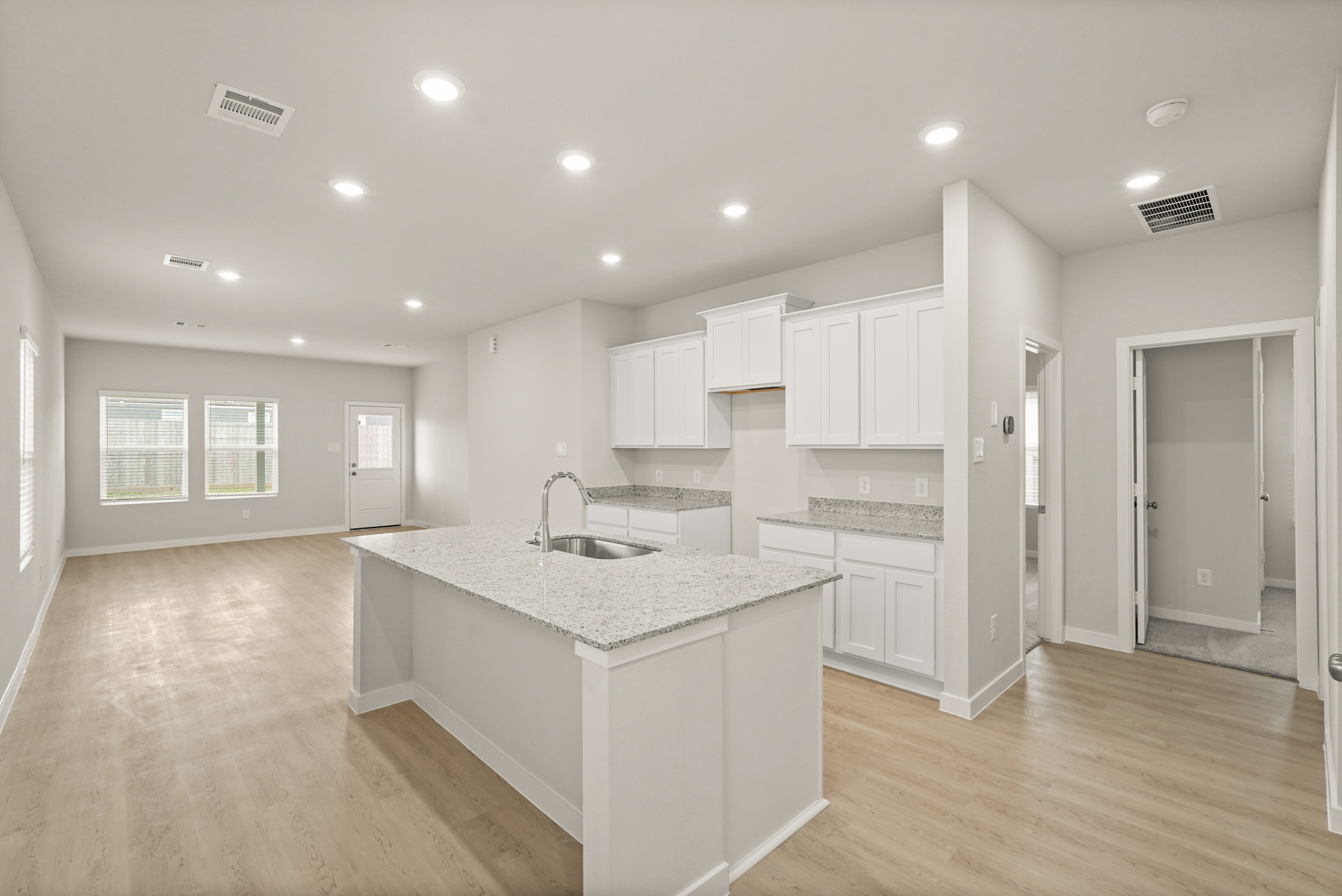 A kitchen with white cabinets.