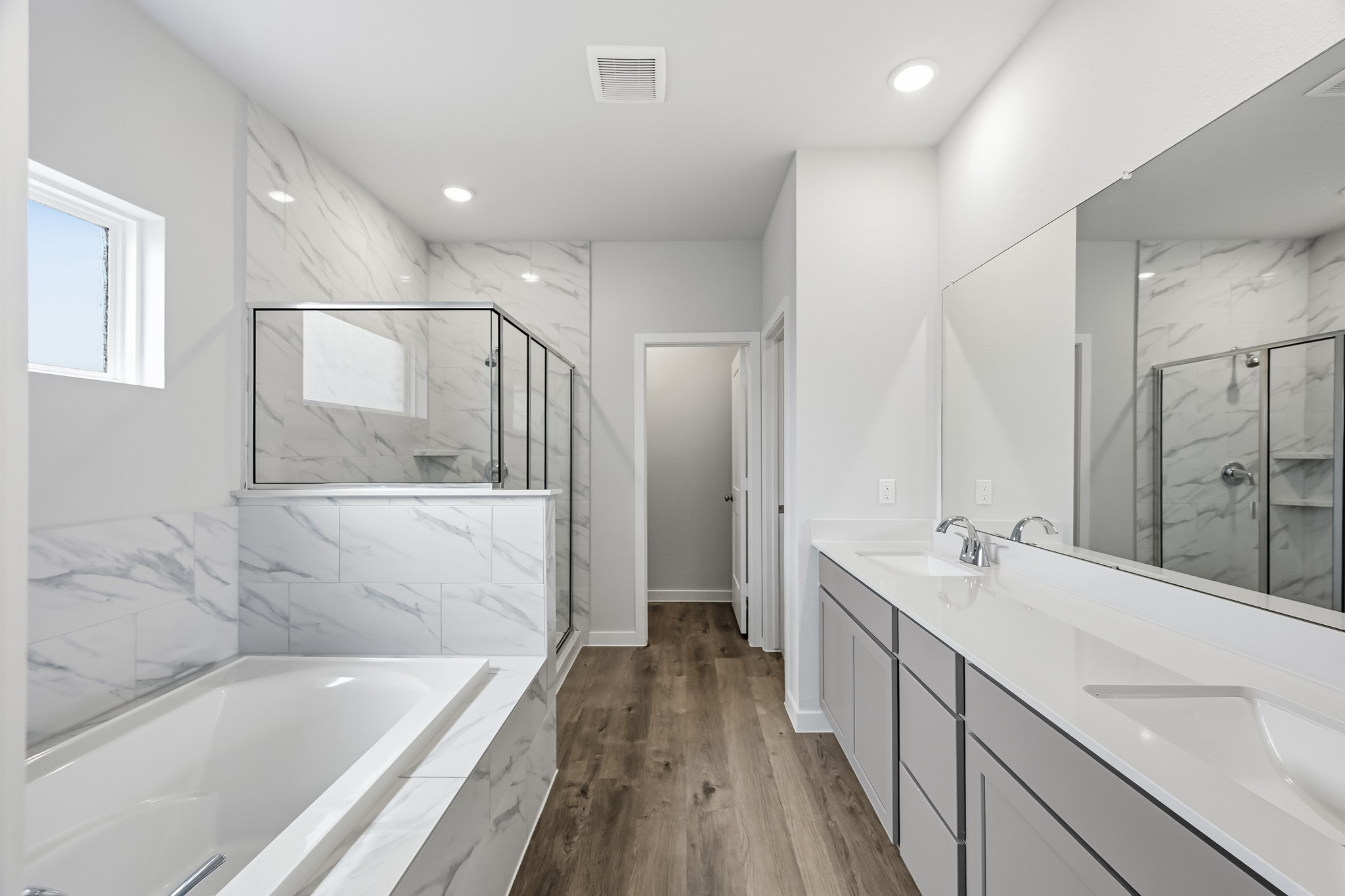 A bathroom with a tub and sink.