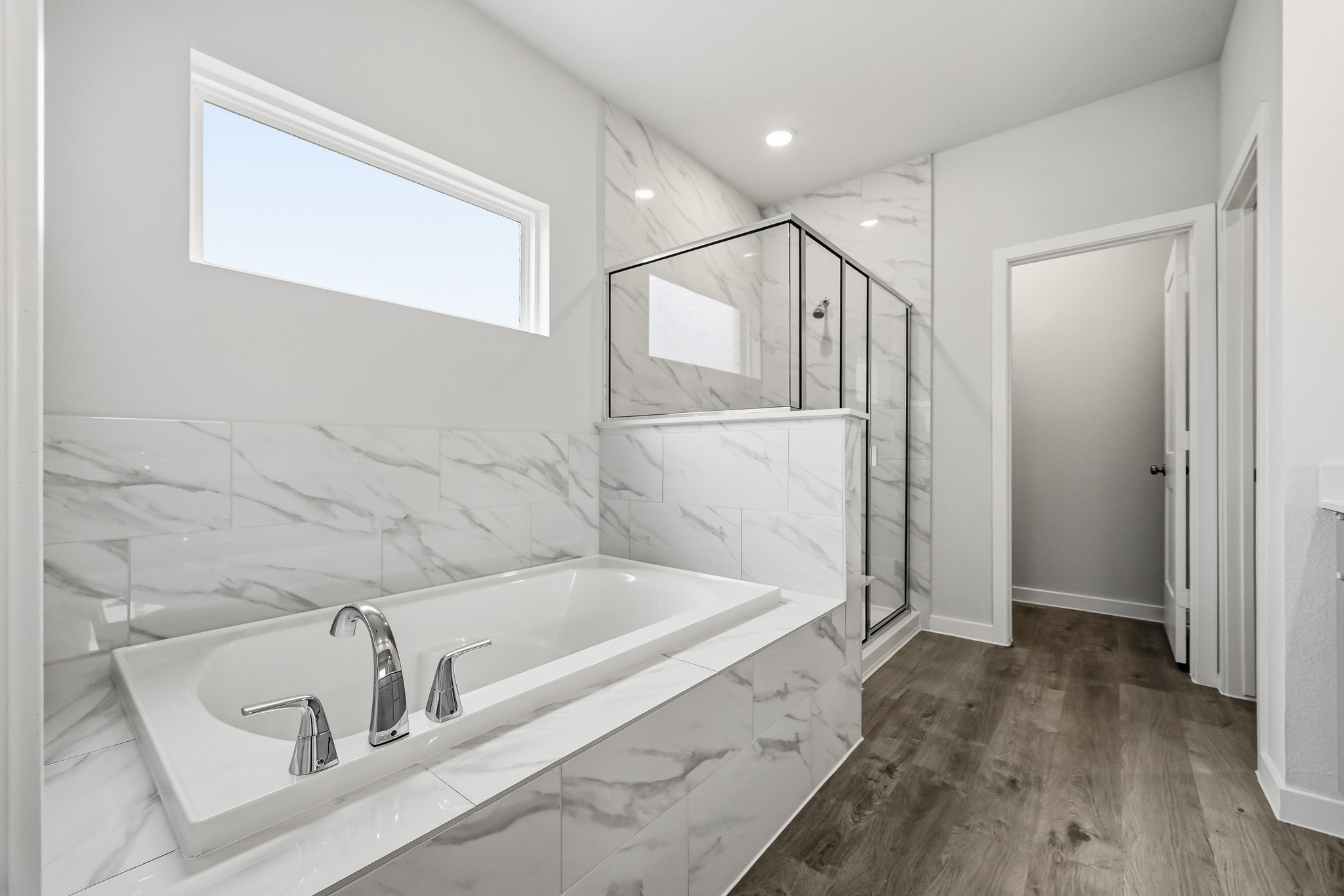 A bathroom with a tub and sink.
