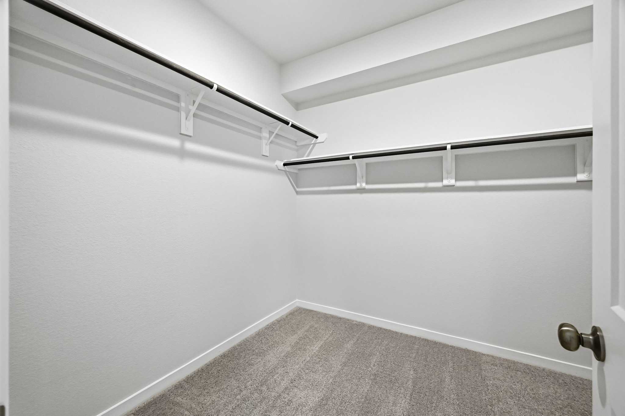 A white wall with a metal railing.