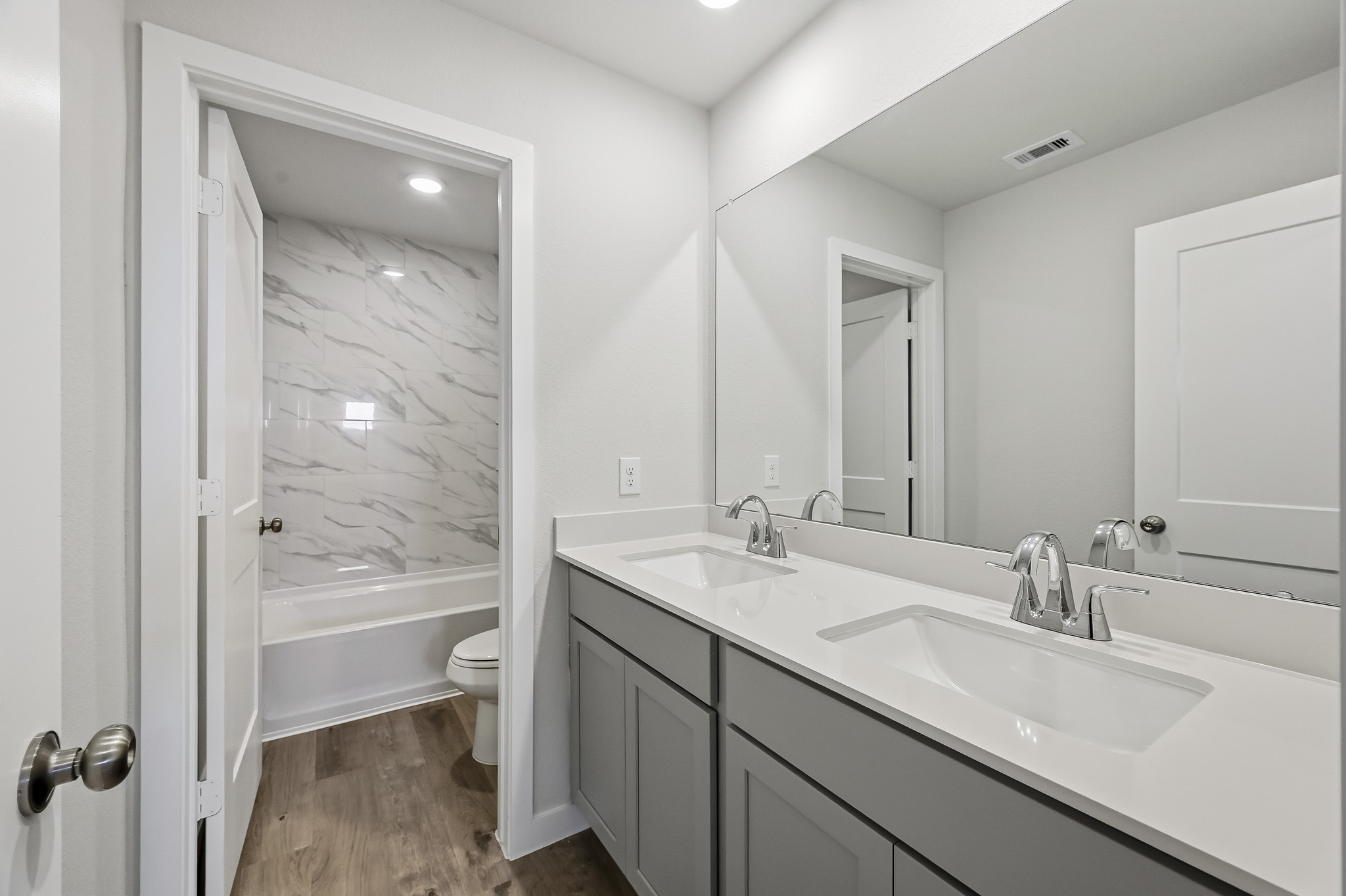 A bathroom with a tub sink and toilet.