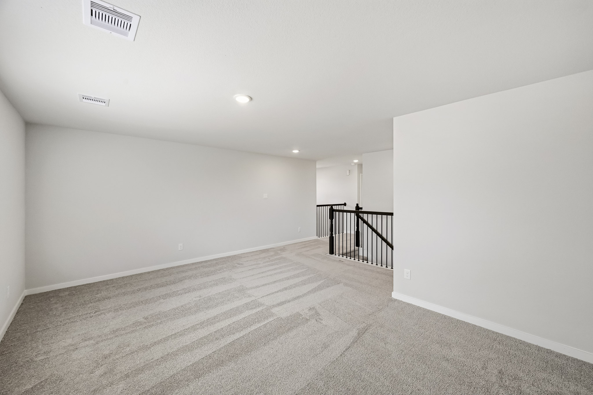 A hallway with a railing.
