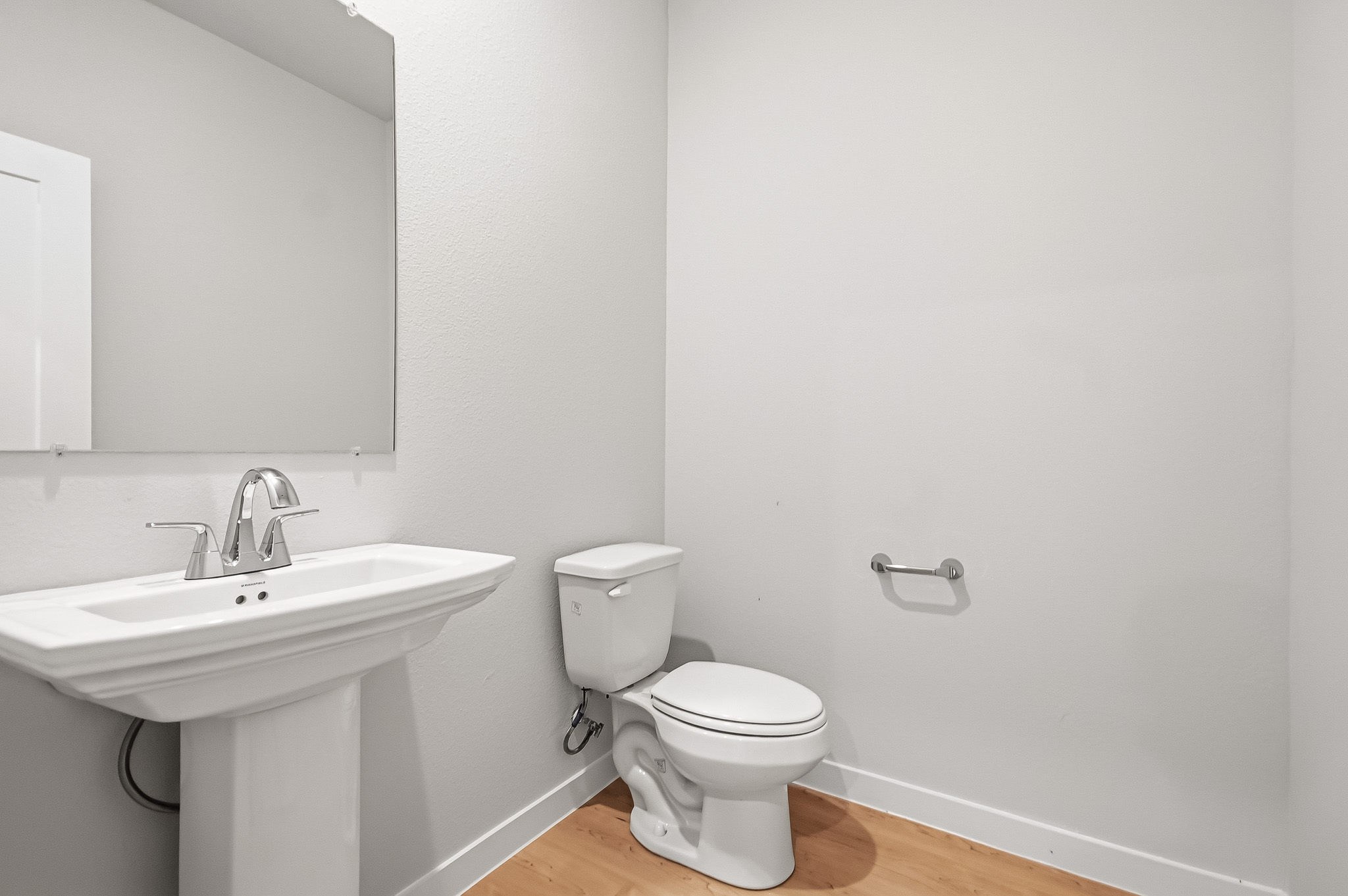 A bathroom with a toilet and sink.