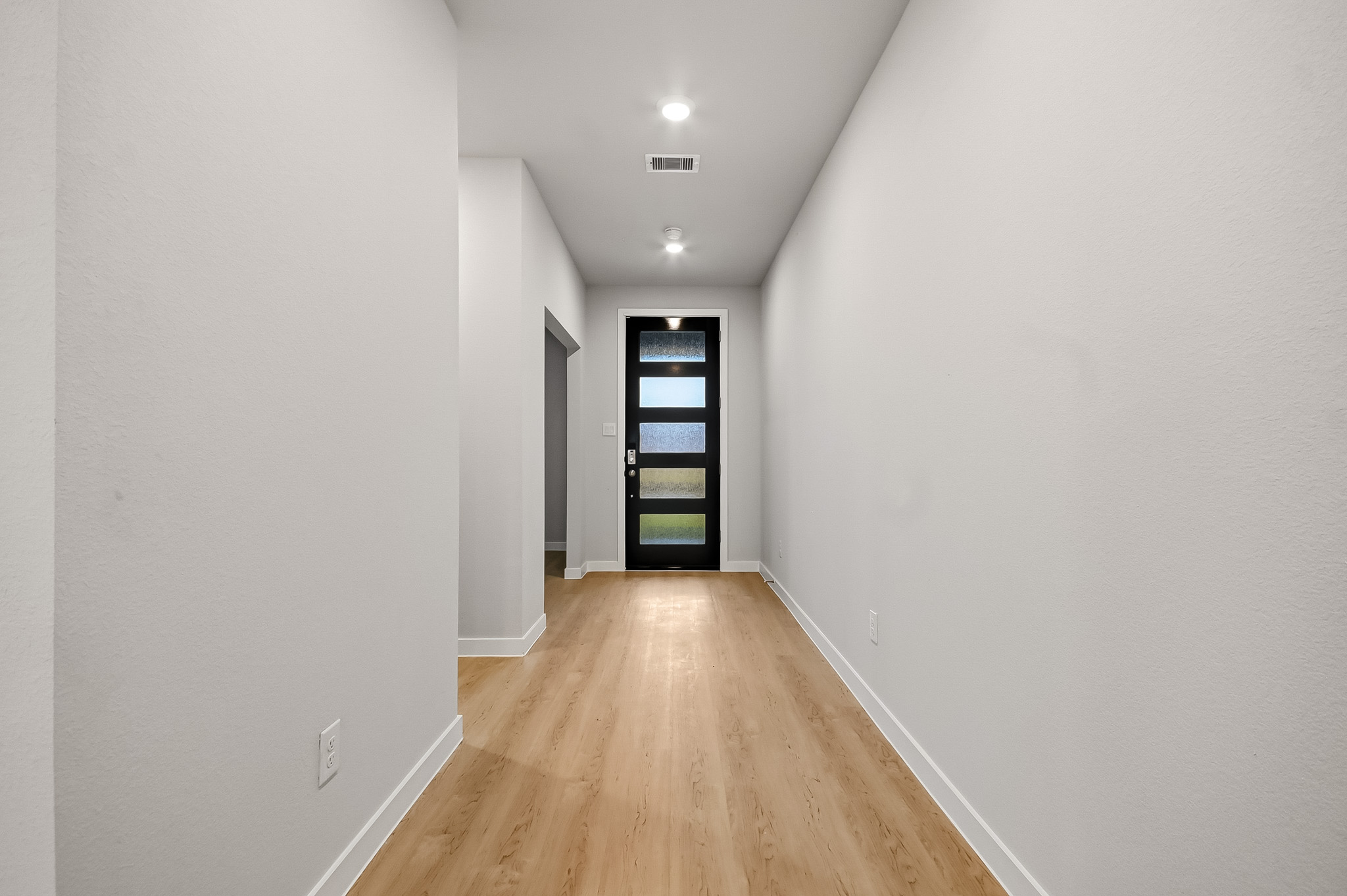 A hallway with white walls.