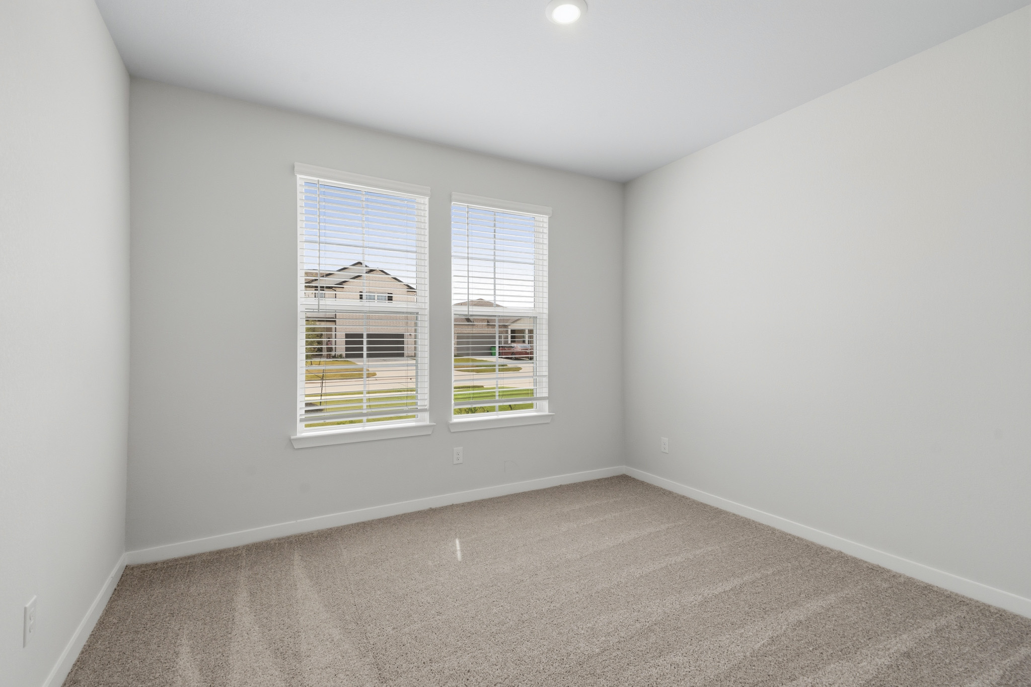 A room with a window and a carpet.