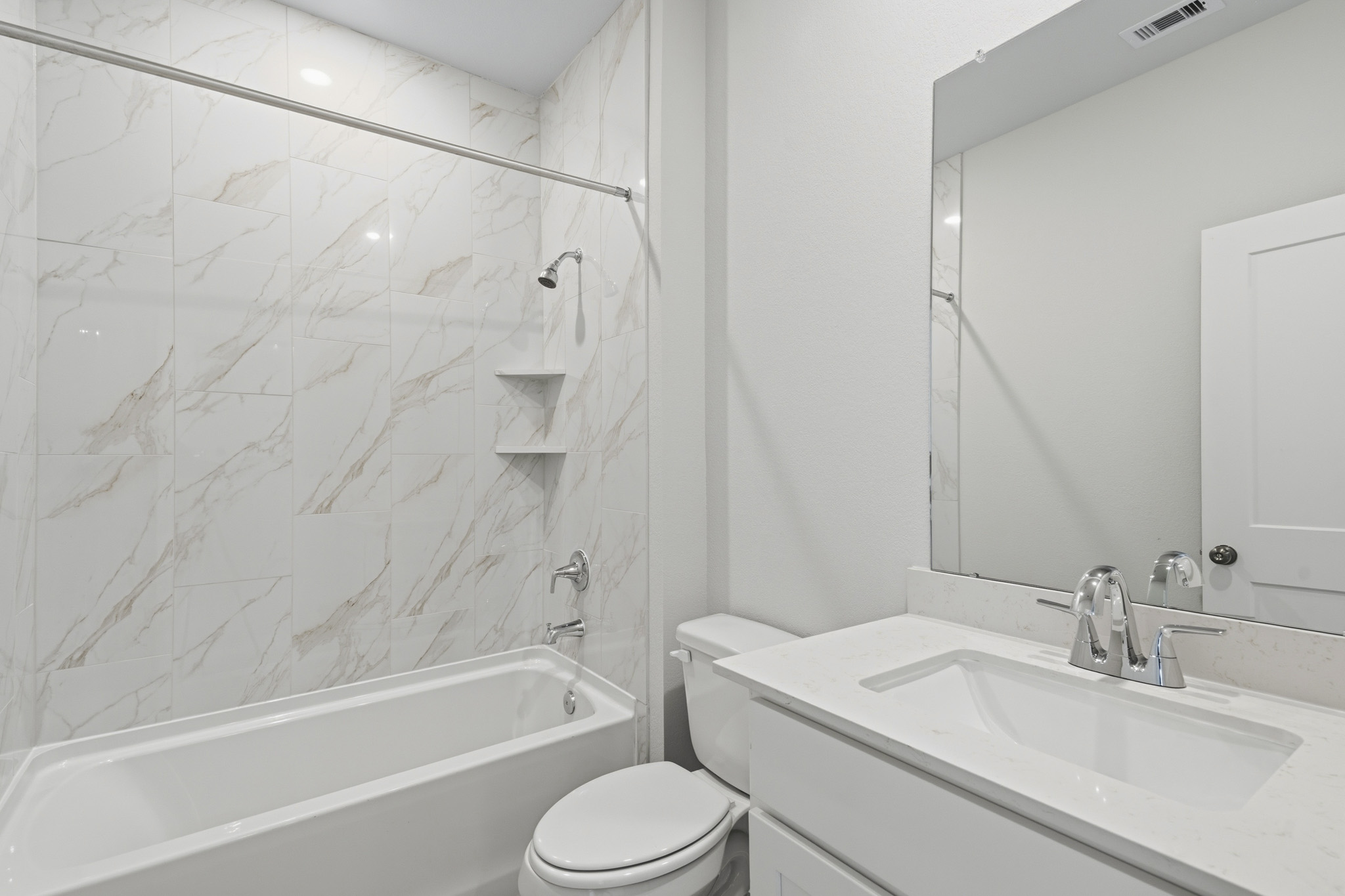 A bathroom with a sink toilet and bathtub.