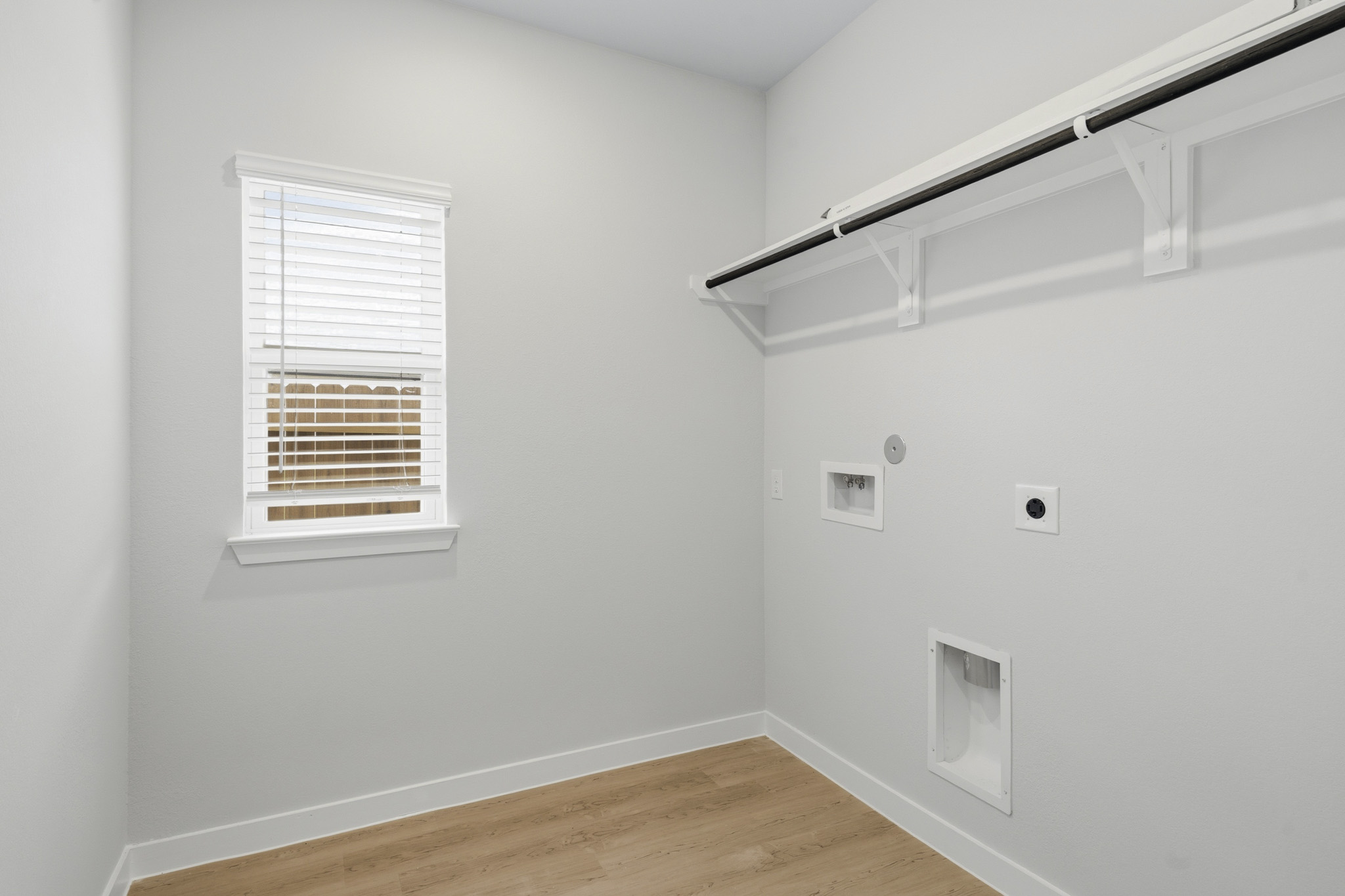 A room with a wood floor and white walls.