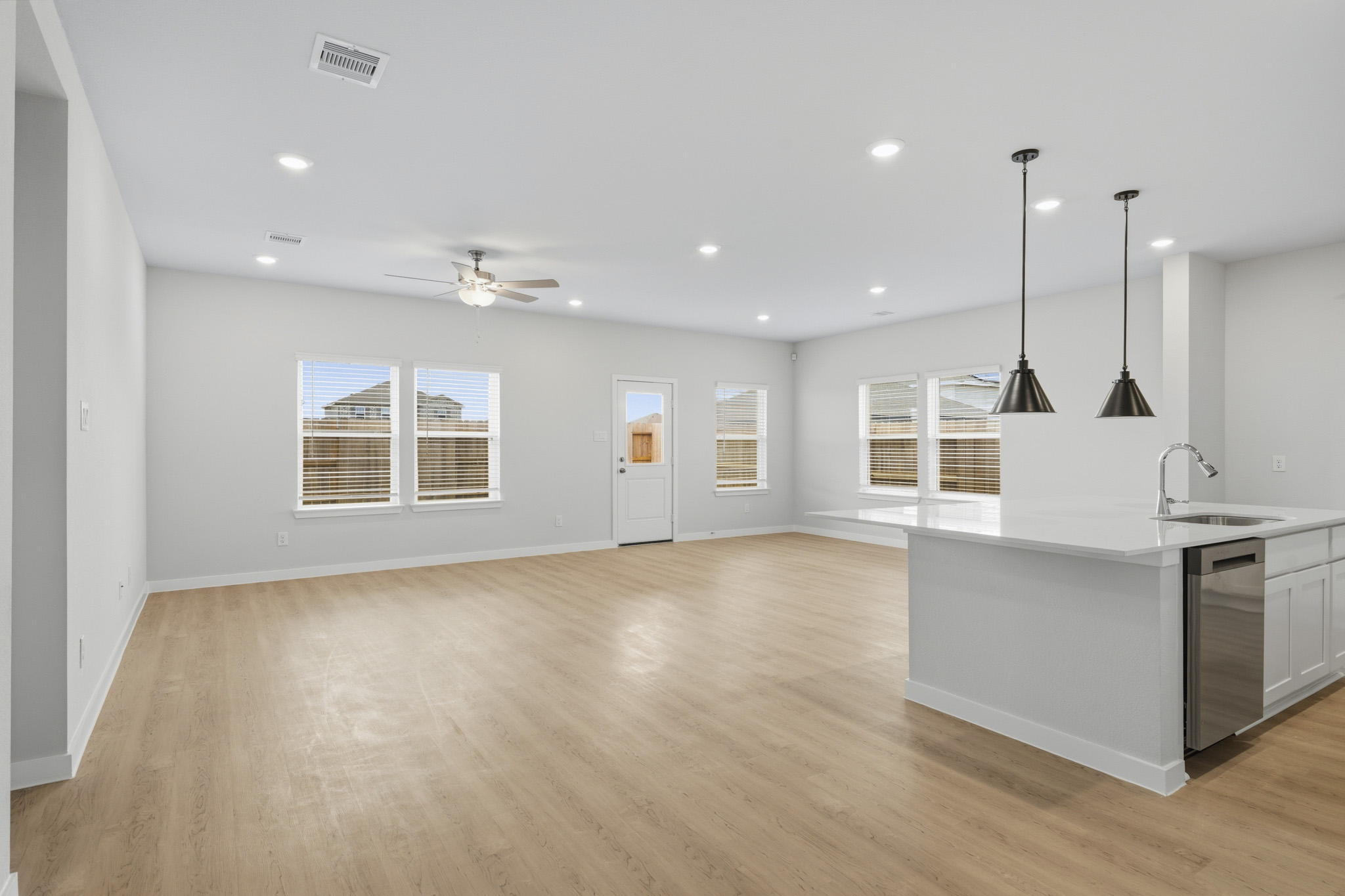 A kitchen with white cabinets.