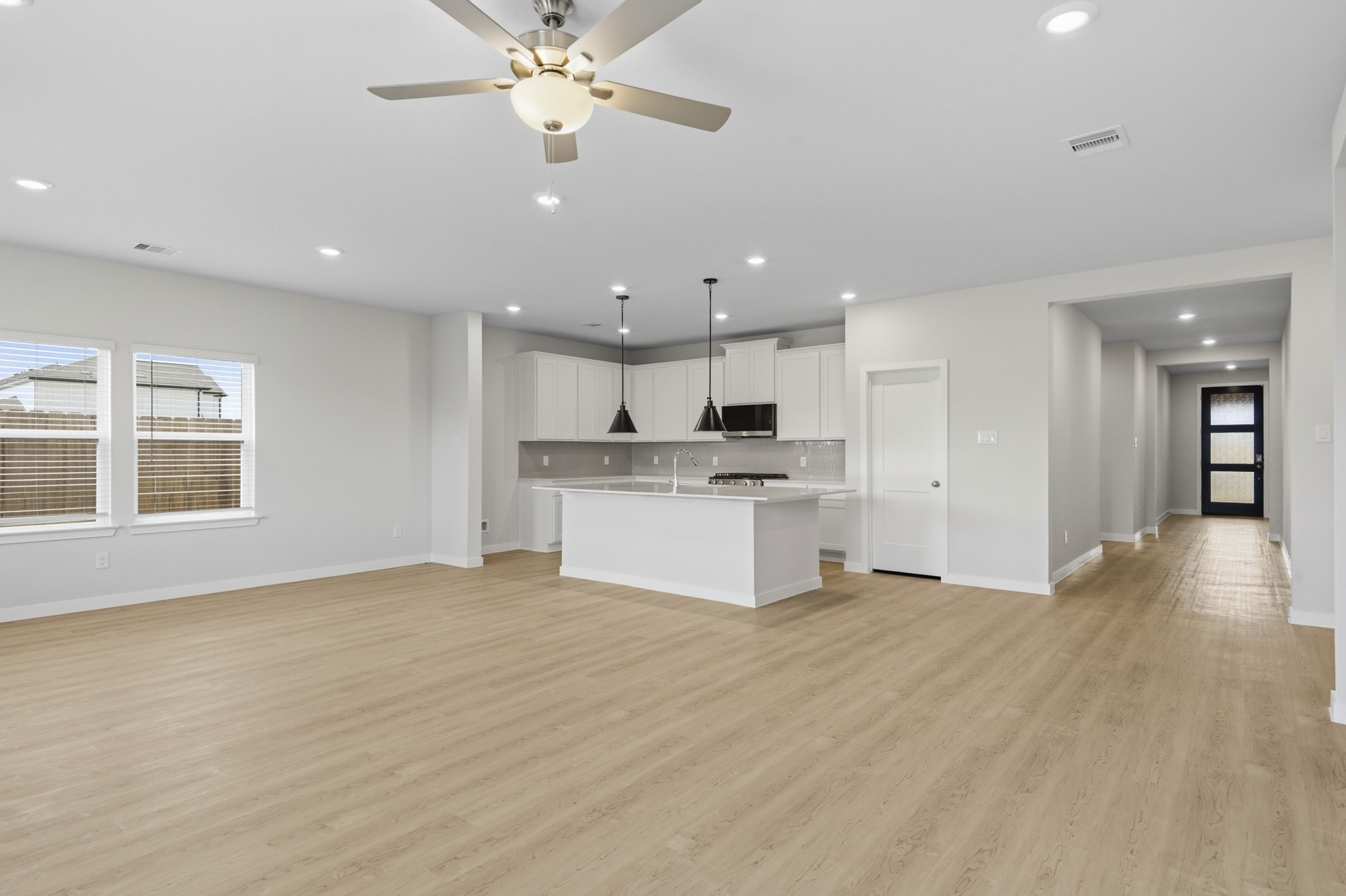 A large kitchen with a wood floor.
