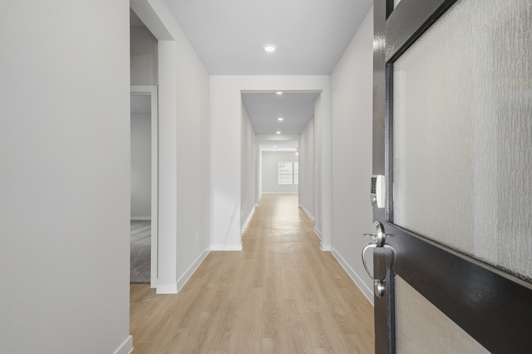 A hallway with white walls.