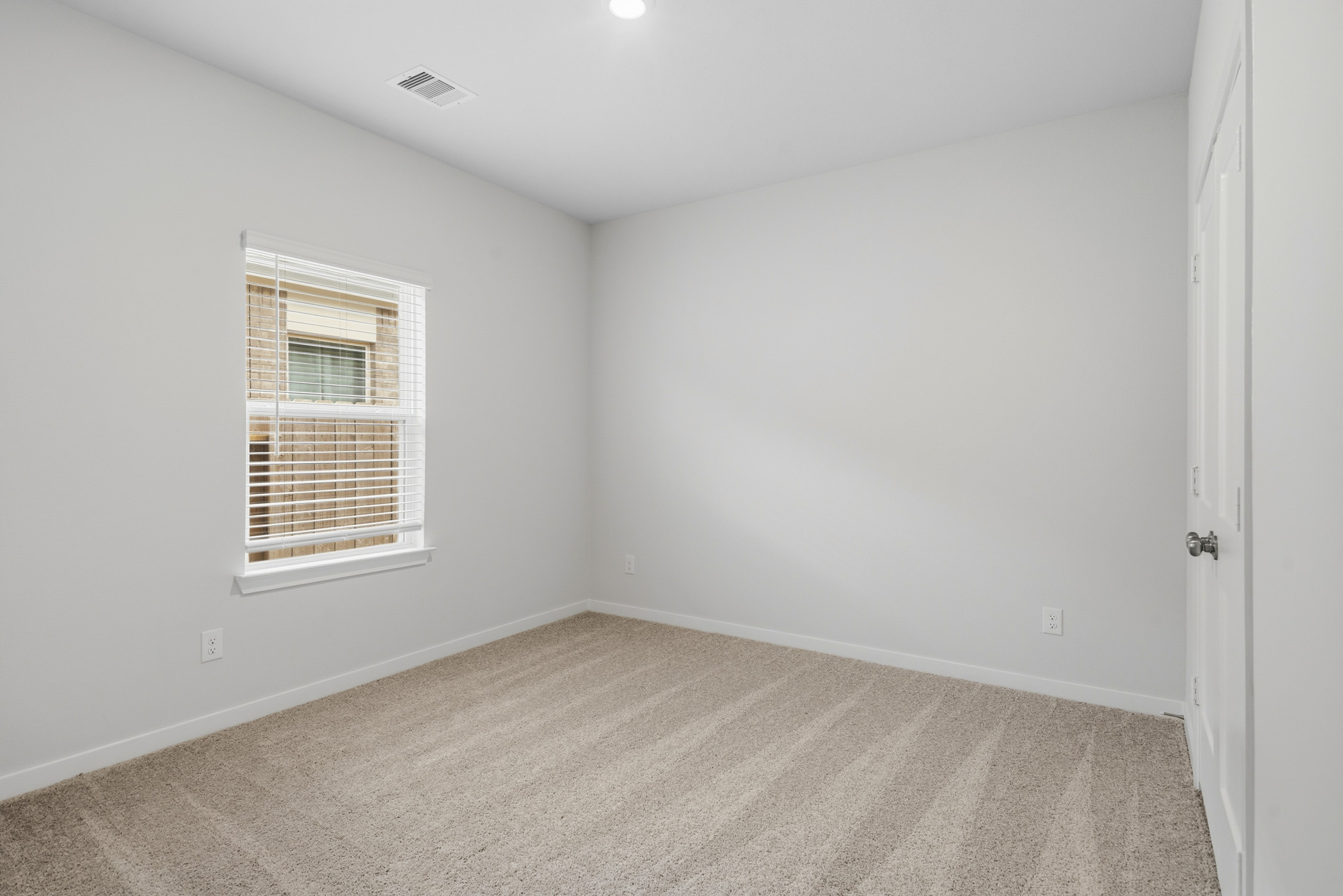 A room with a window and a door.