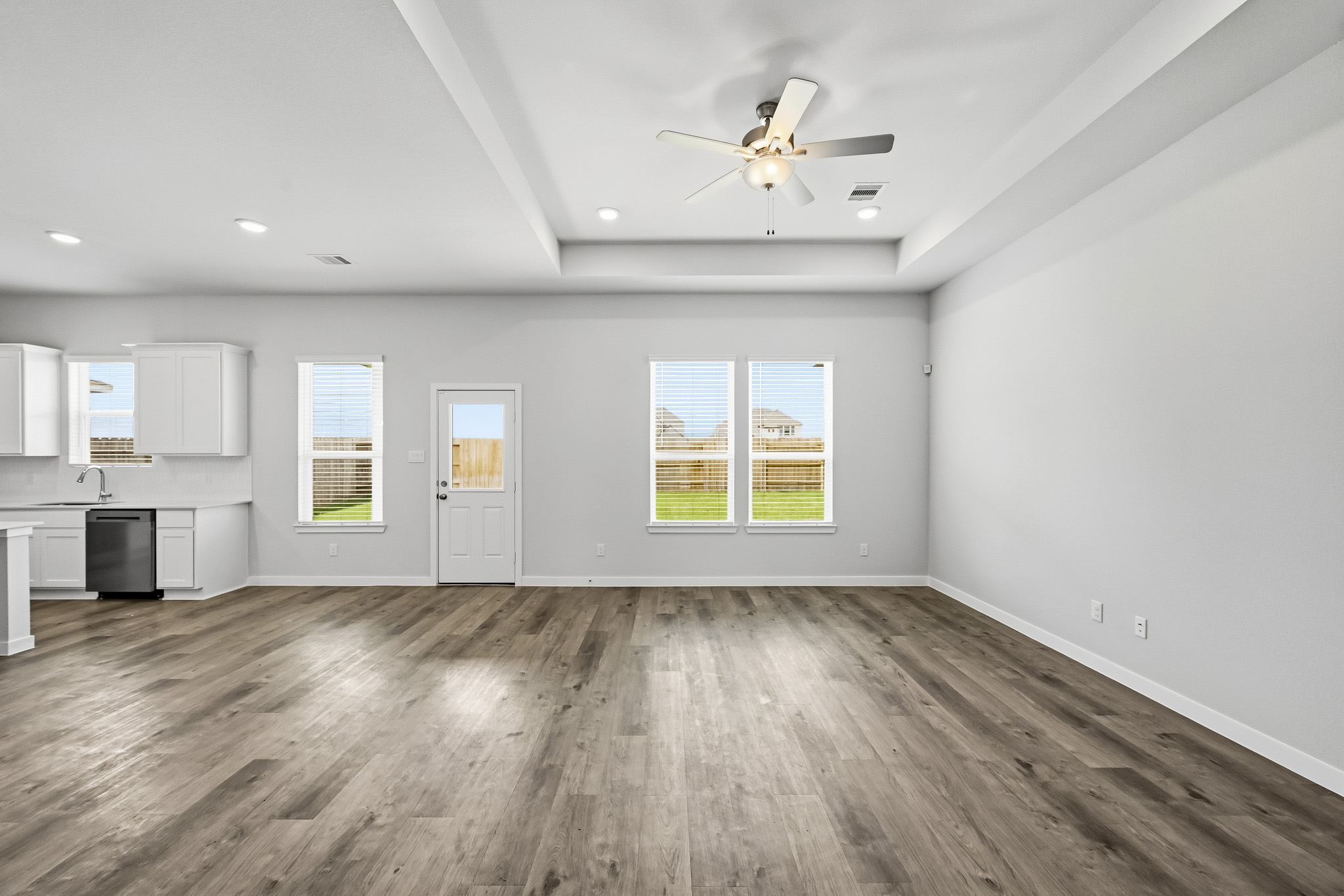 A room with a wood floor and a ceiling fan.