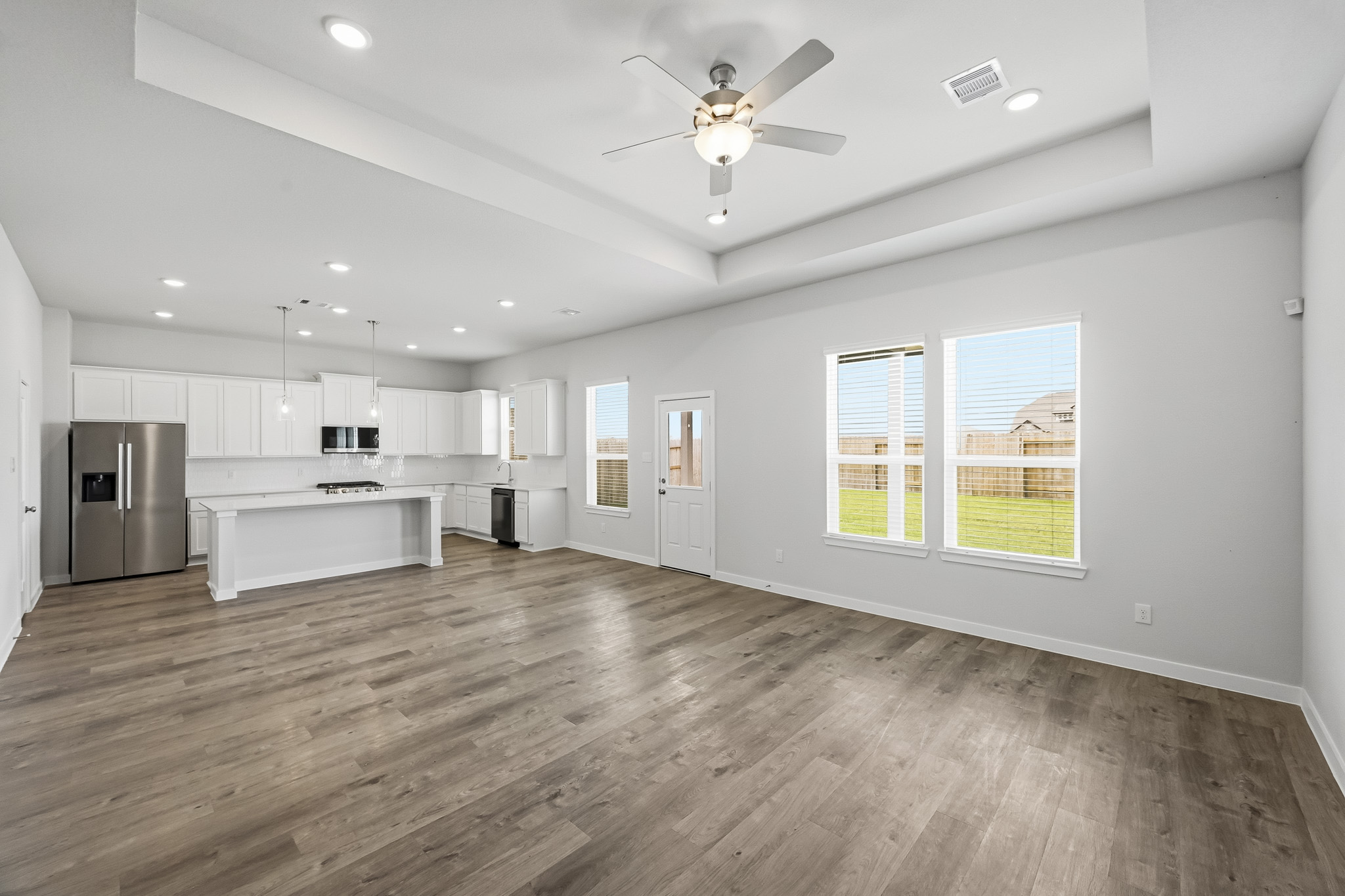 A kitchen with white cabinets.