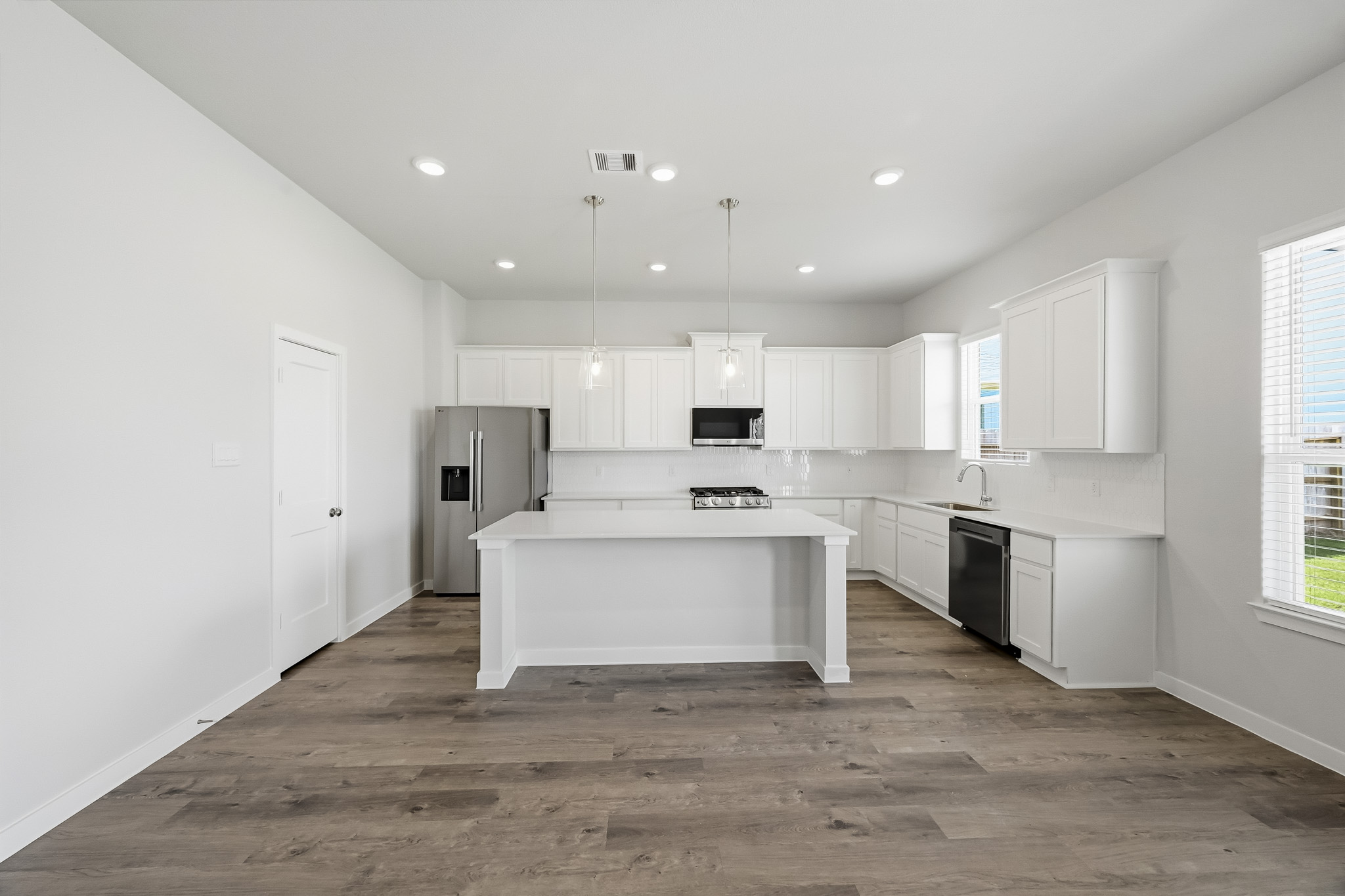 A kitchen with white cabinets.