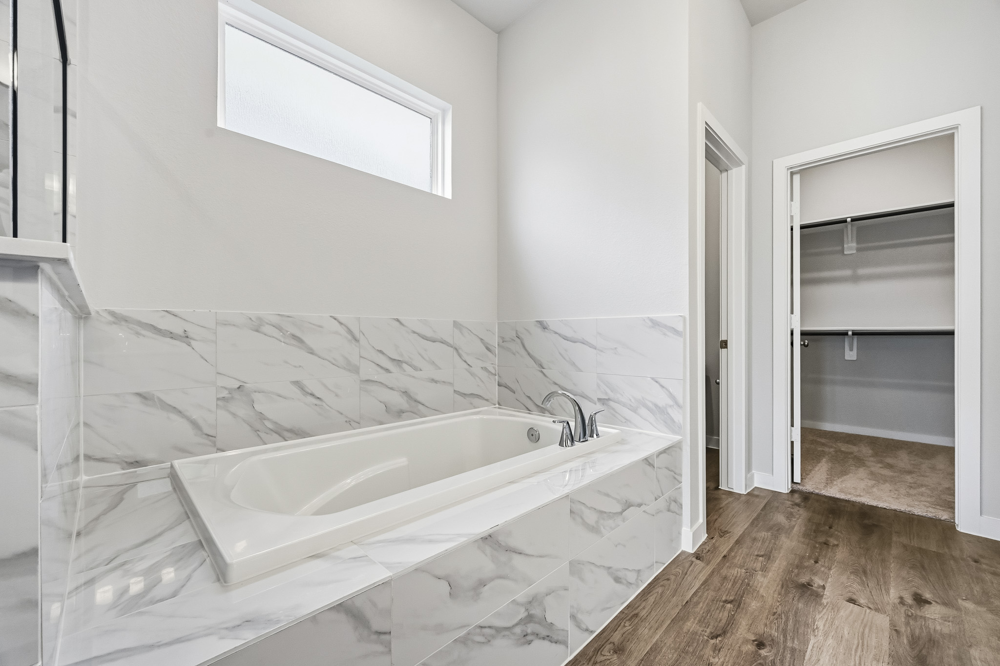 A bathtub in a bathroom.