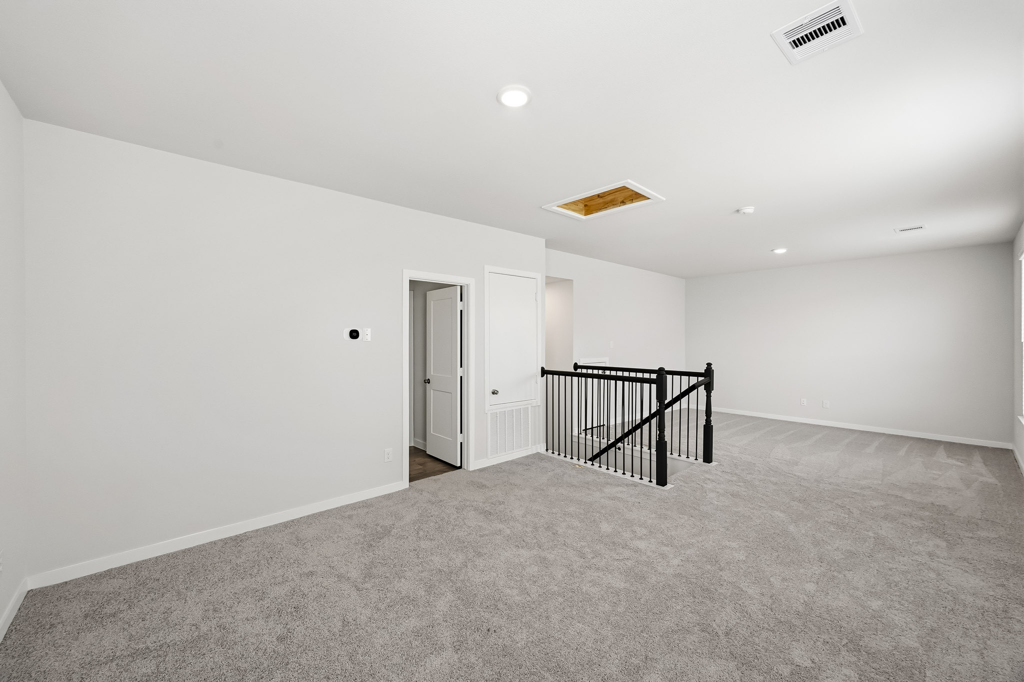 A hallway with a railing and a railing.