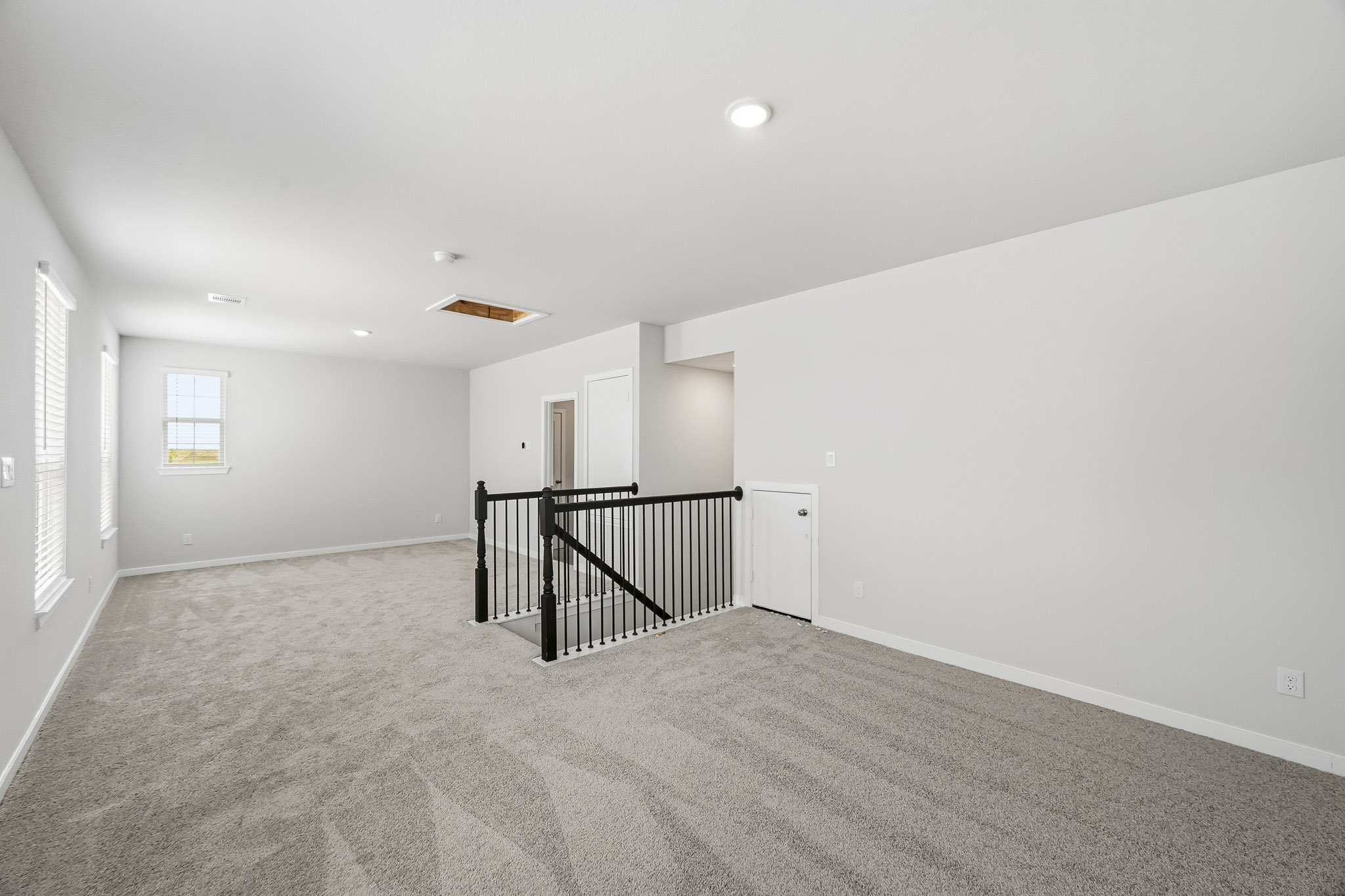 A hallway with a railing.