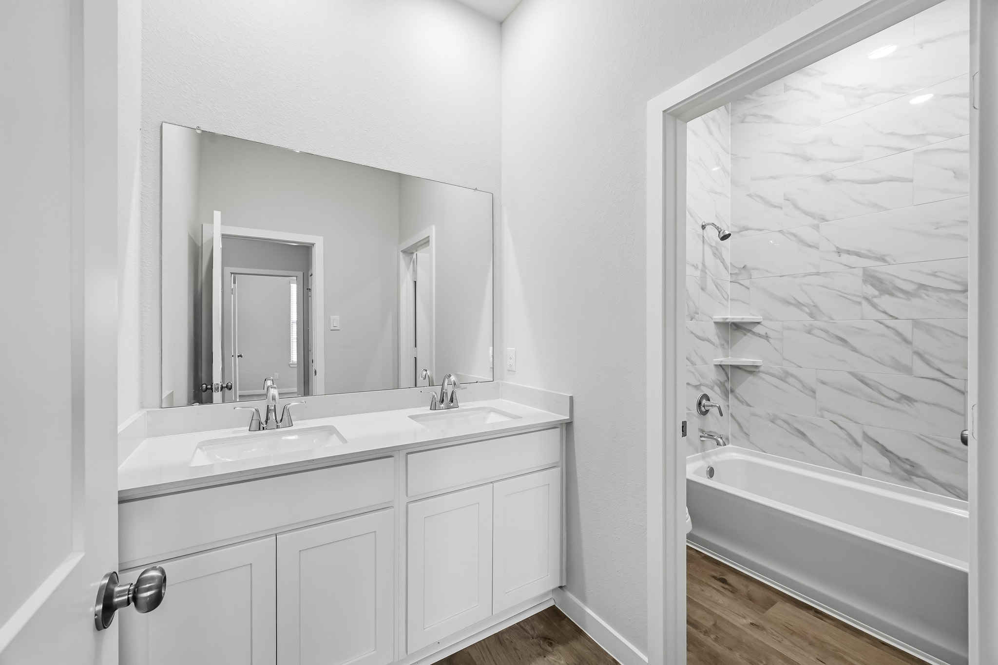 A bathroom with a tub sink and a bathtub.