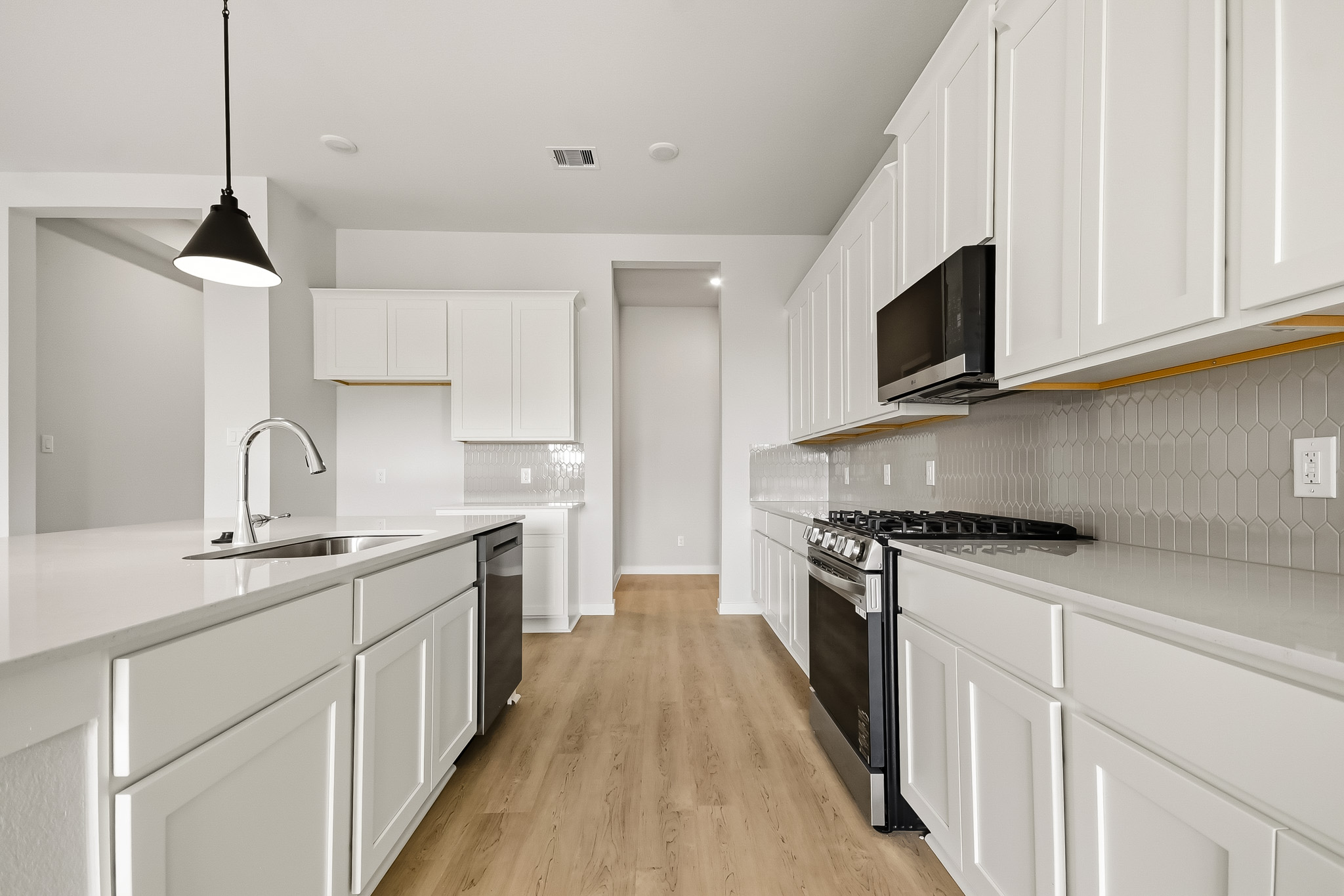 A kitchen with white cabinets.