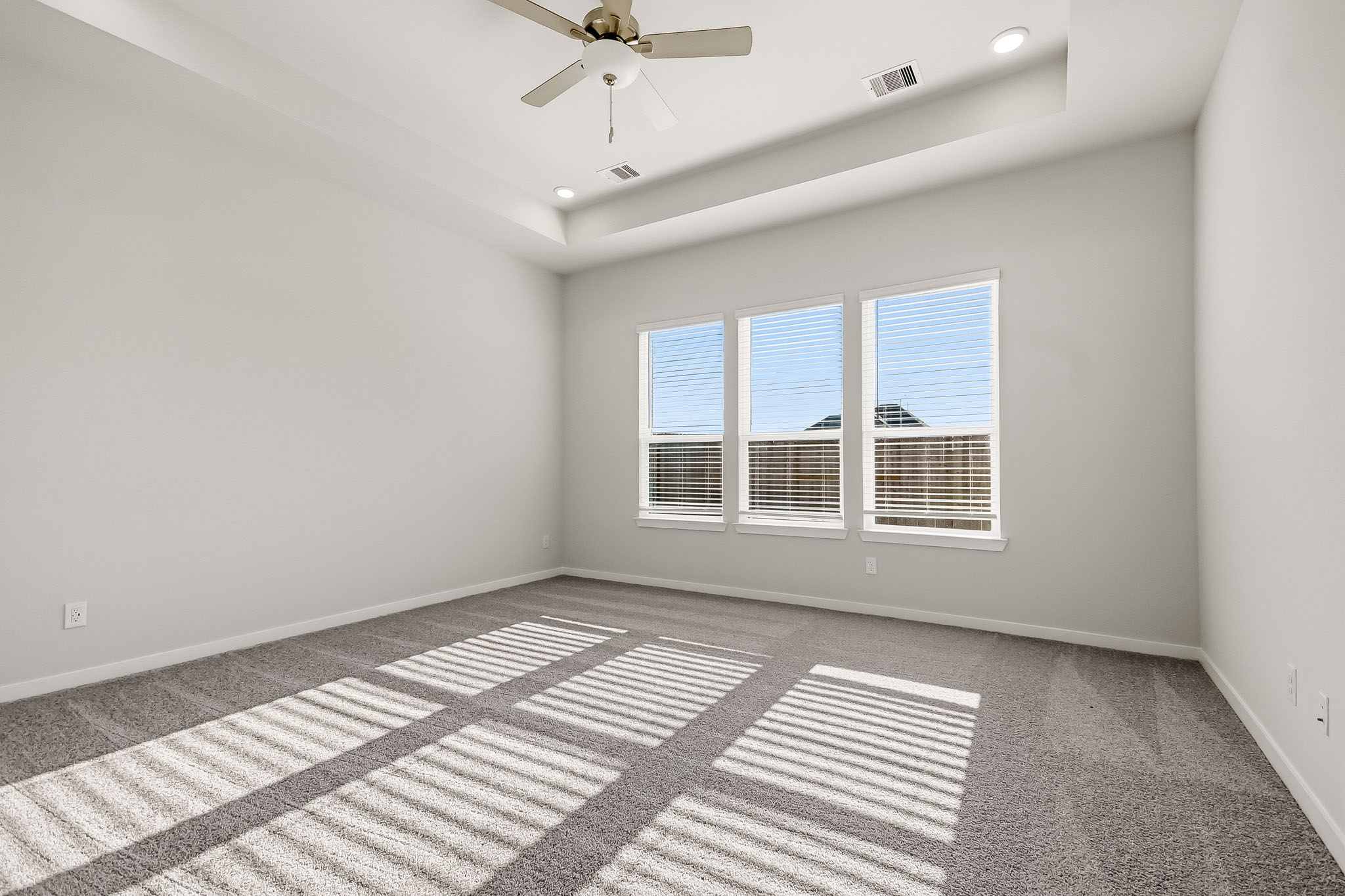 A room with a tile floor and a ceiling fan.