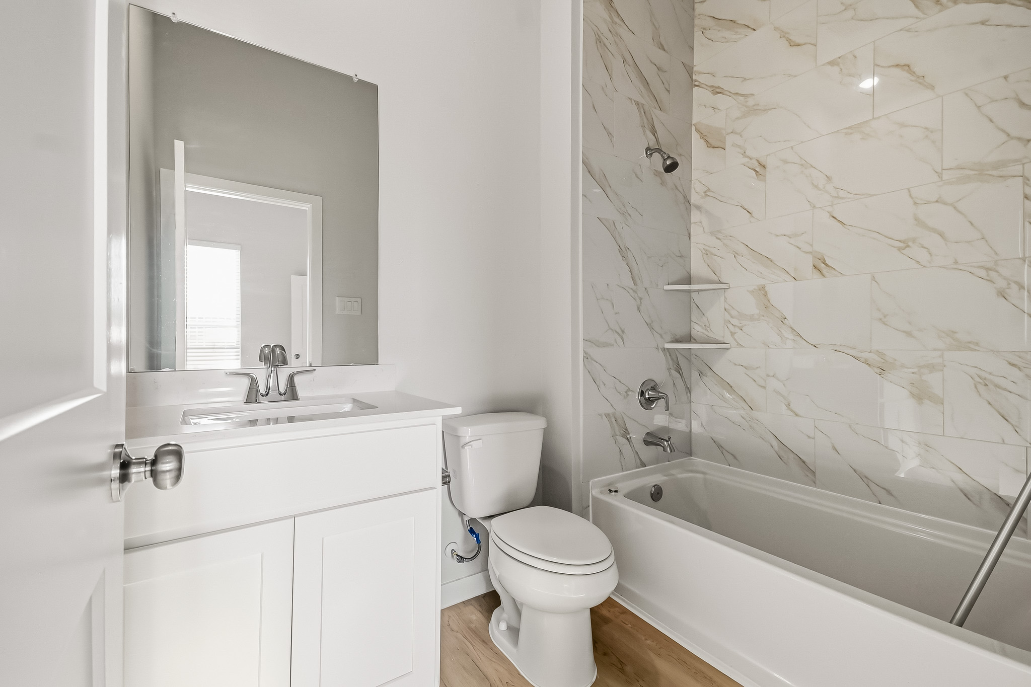 A bathroom with a tub toilet and sink.