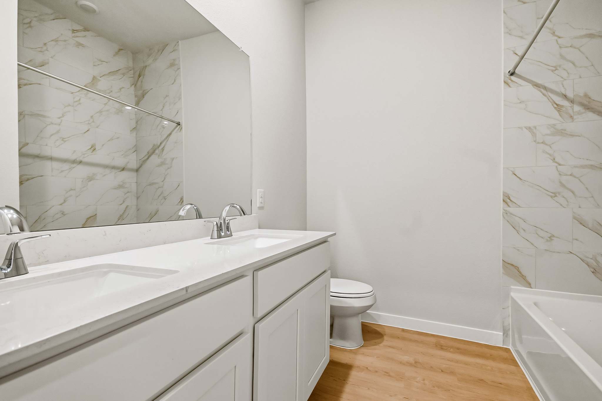 A bathroom with a tub sink and toilet.