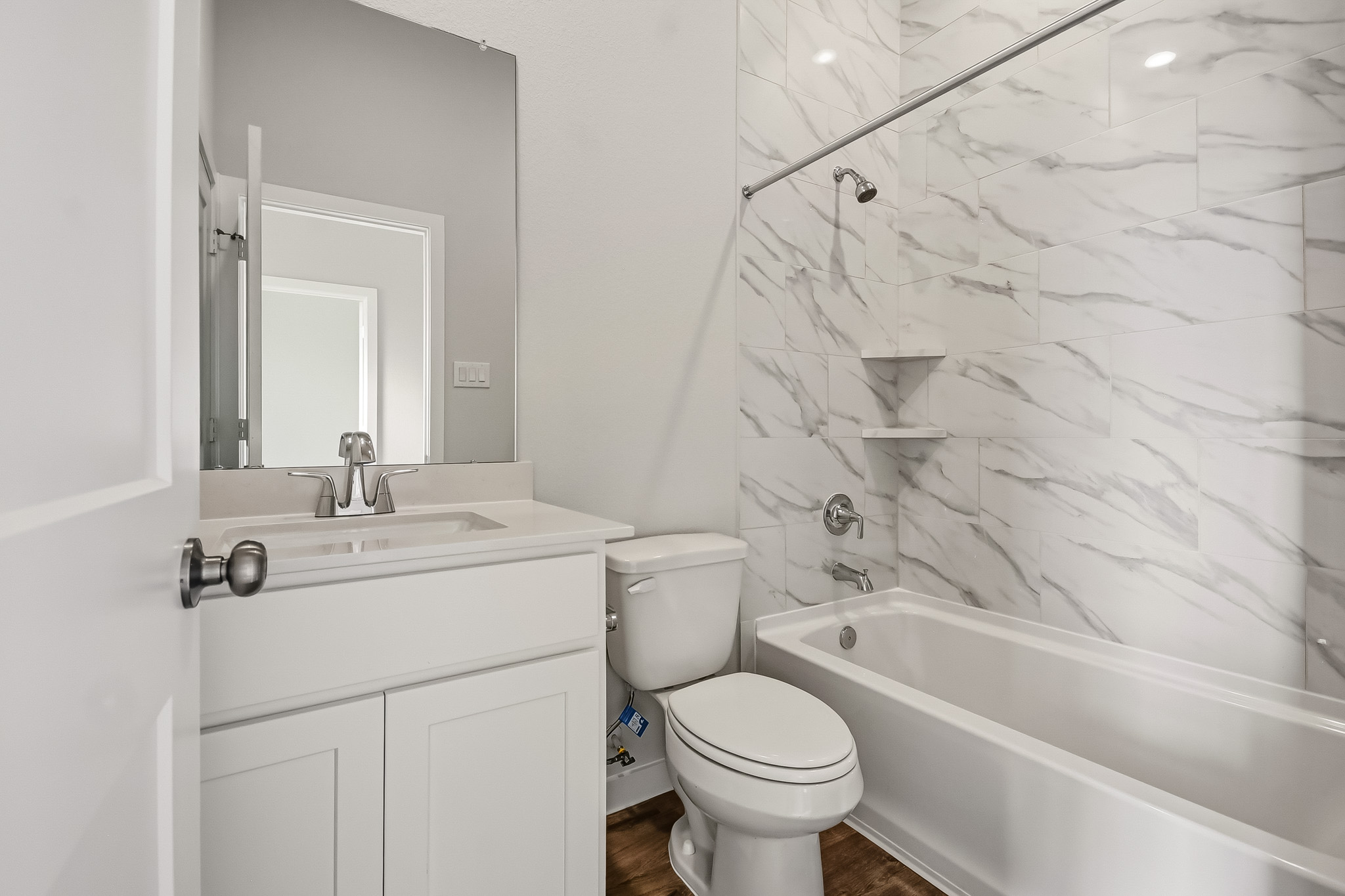 A bathroom with a tub toilet and sink.