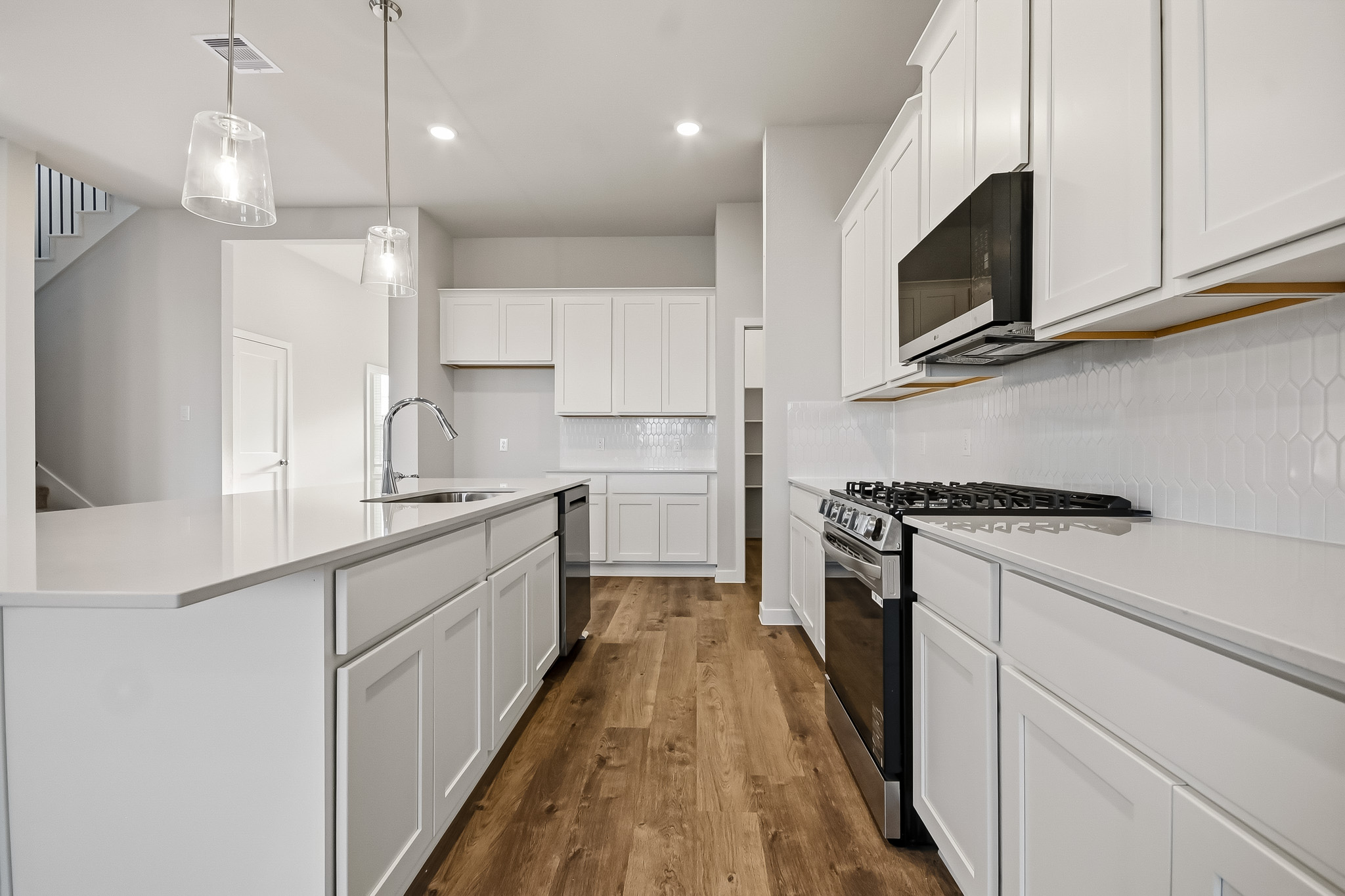 A kitchen with white cabinets.