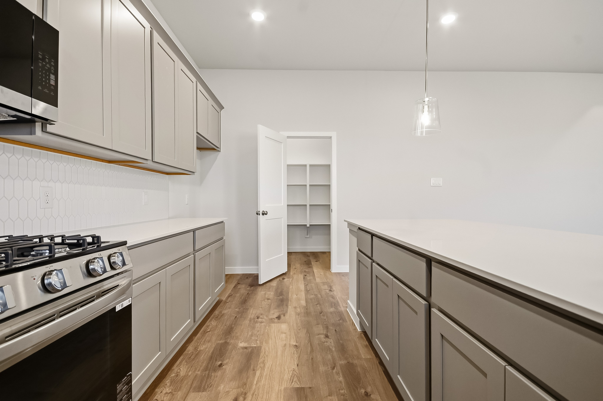 A kitchen with white cabinets.