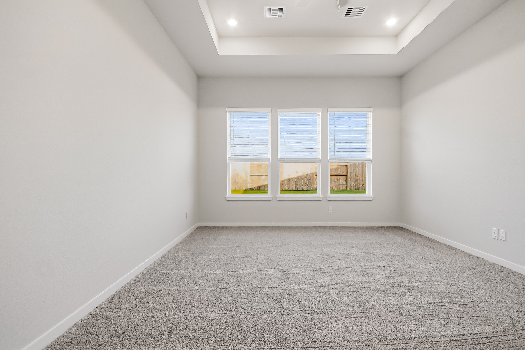 A room with a window and a carpet.