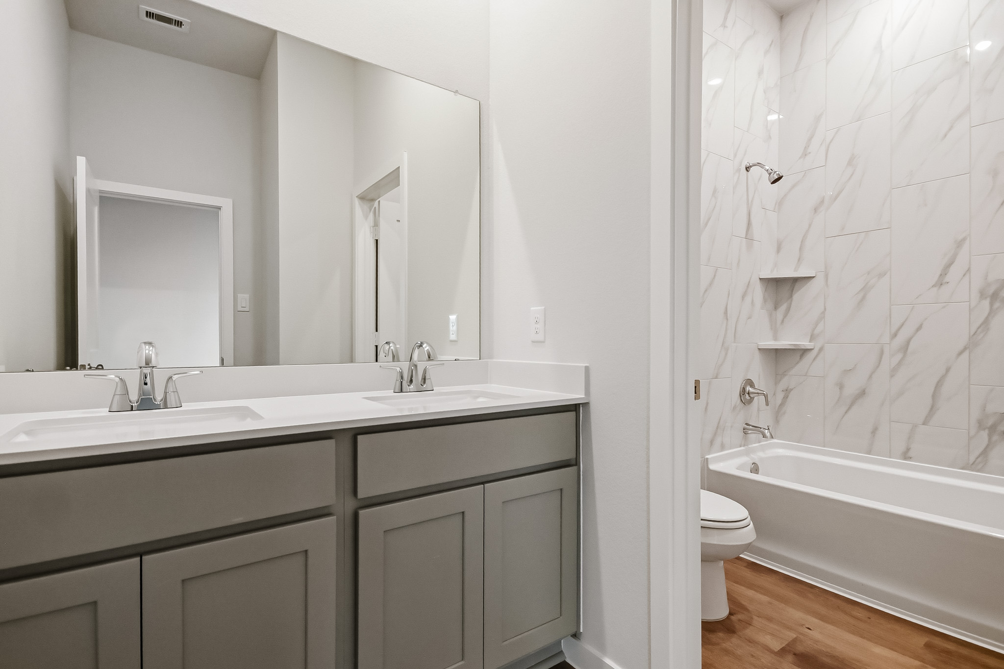 A bathroom with a tub sink and toilet.