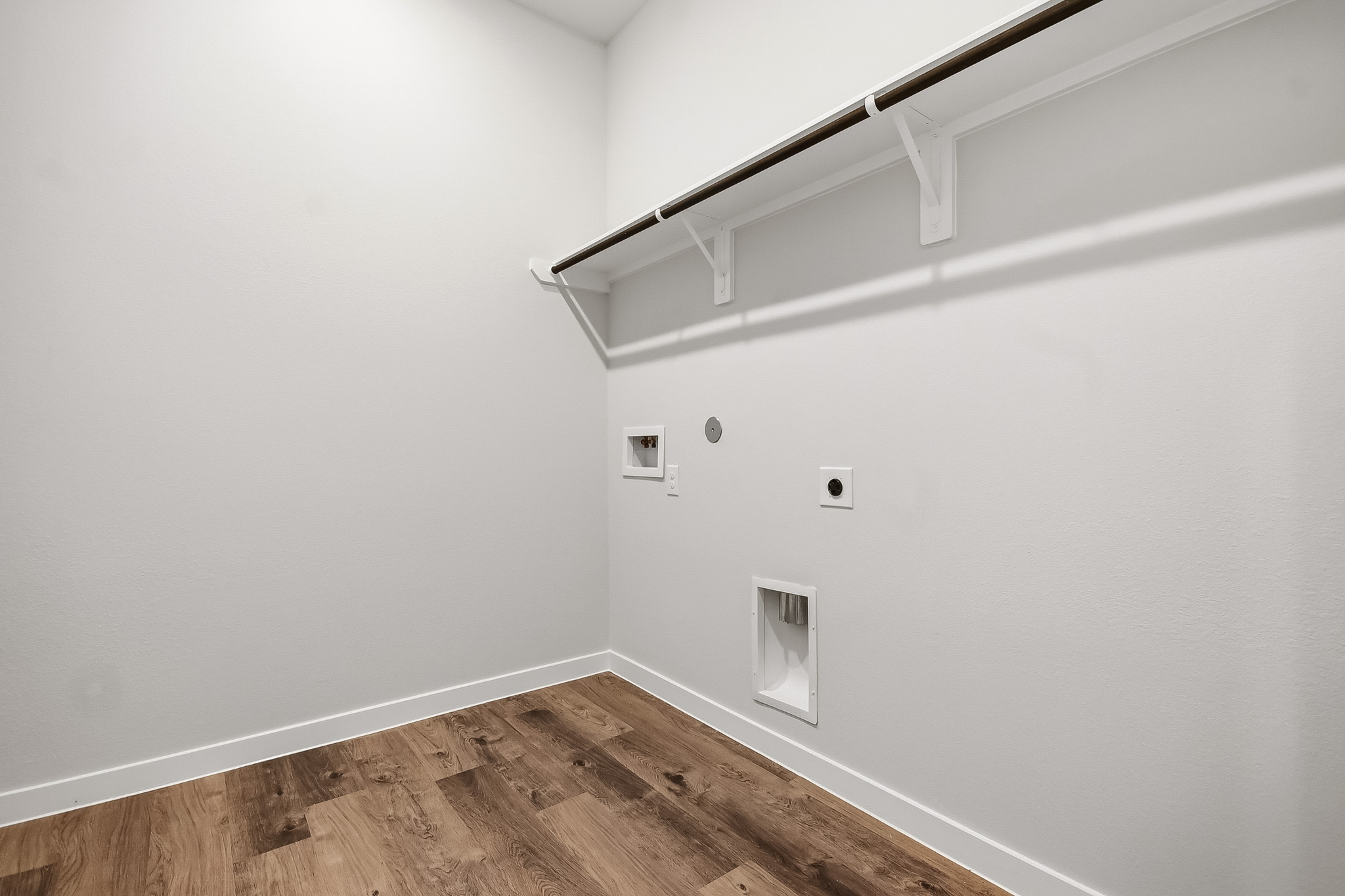 A white room with a wood floor.