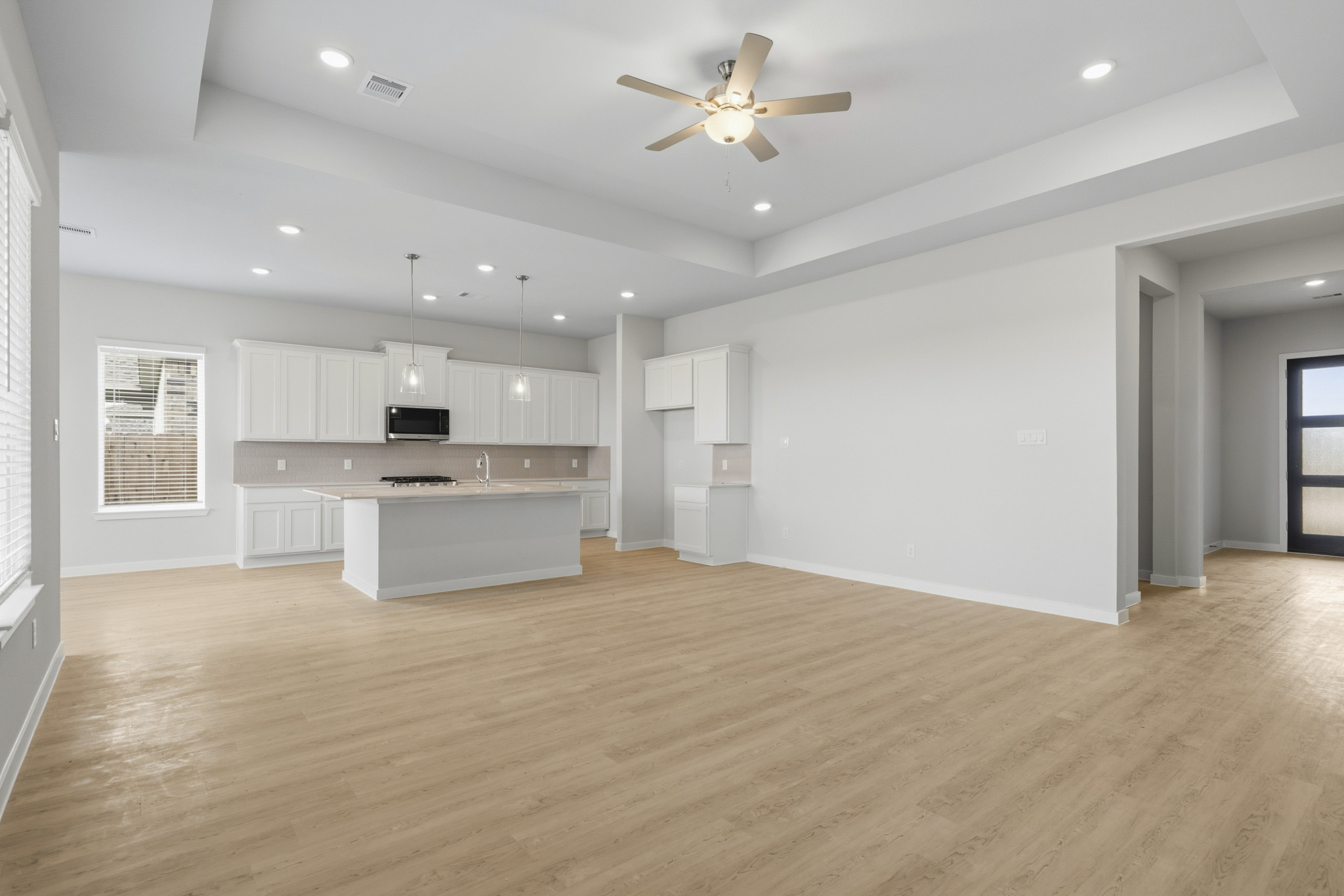 A large kitchen with white cabinets.