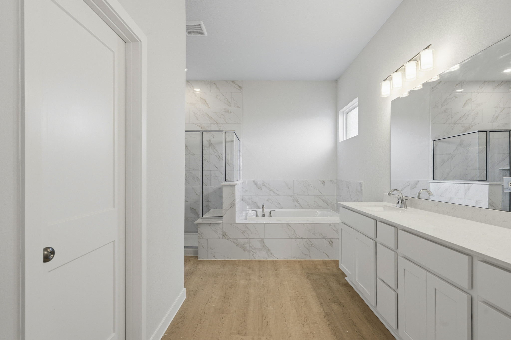 A bathroom with a tub and sink.