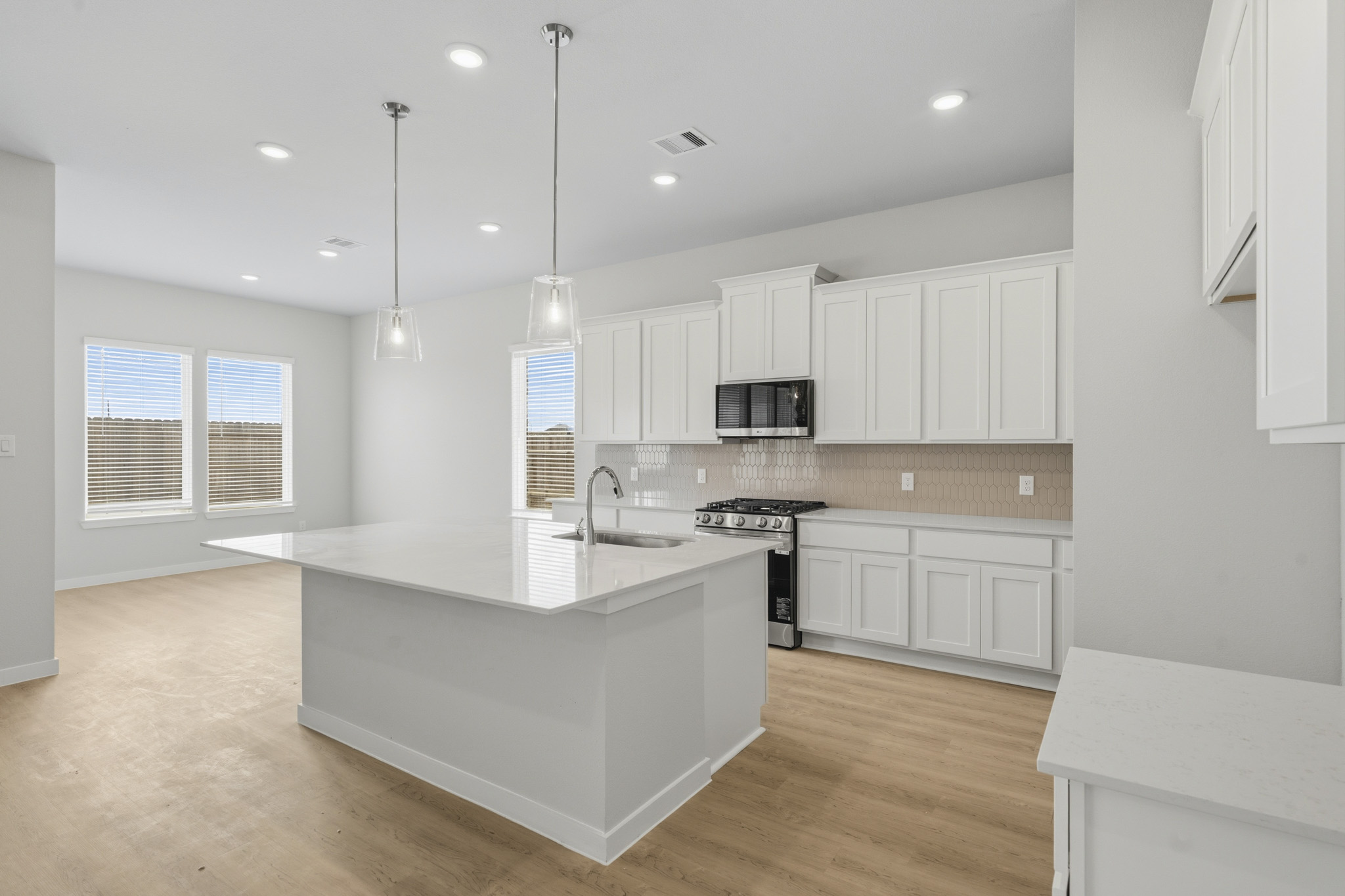 A kitchen with white cabinets.