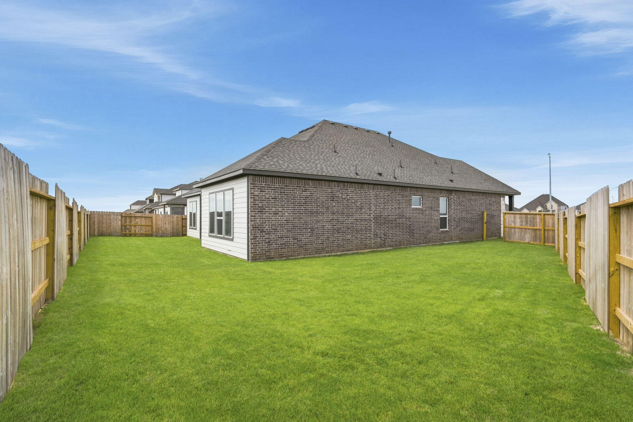 A house in a grassy field.