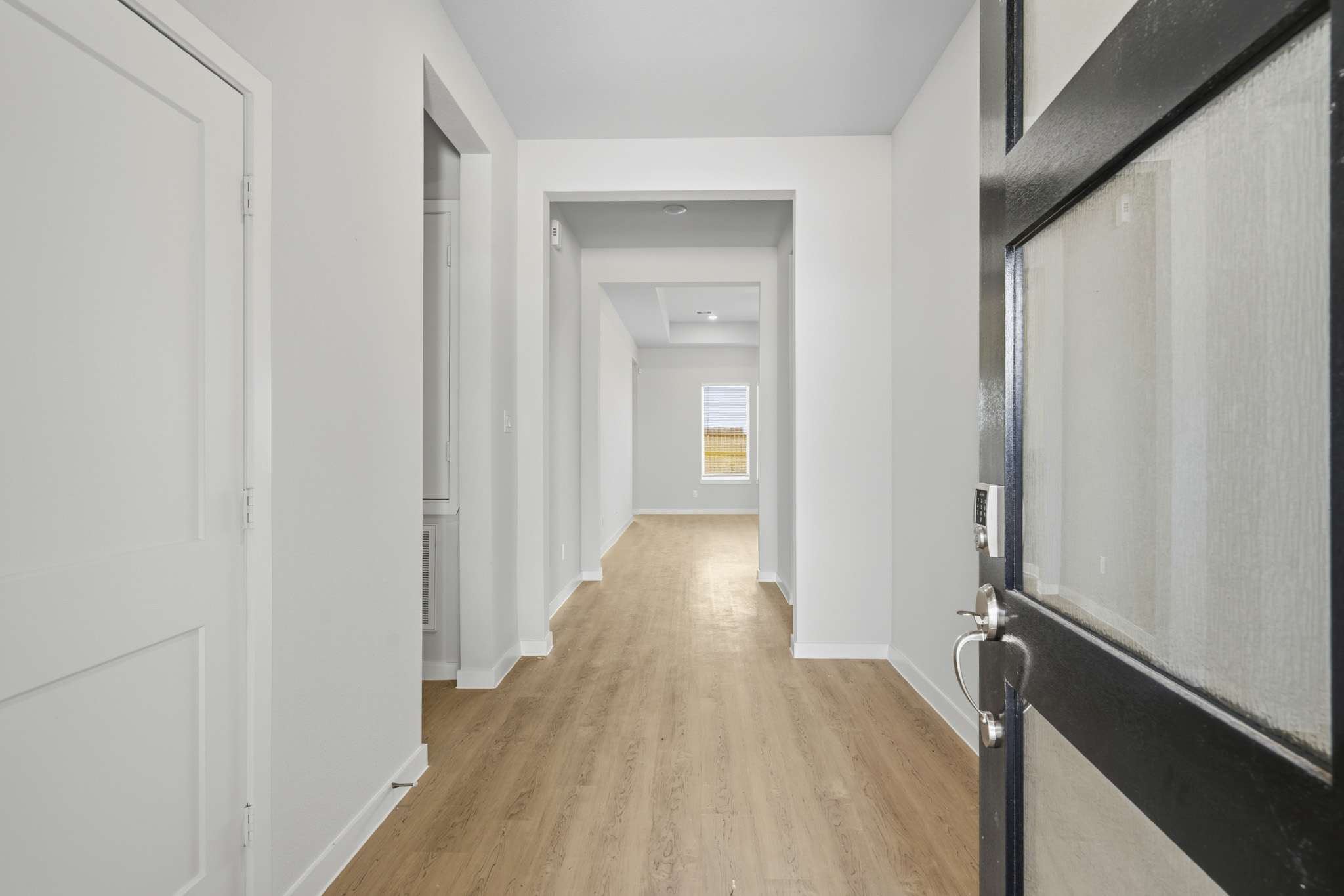 A hallway with white walls.