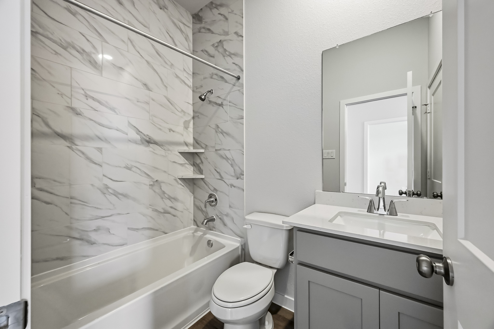 A bathroom with a tub sink and toilet.