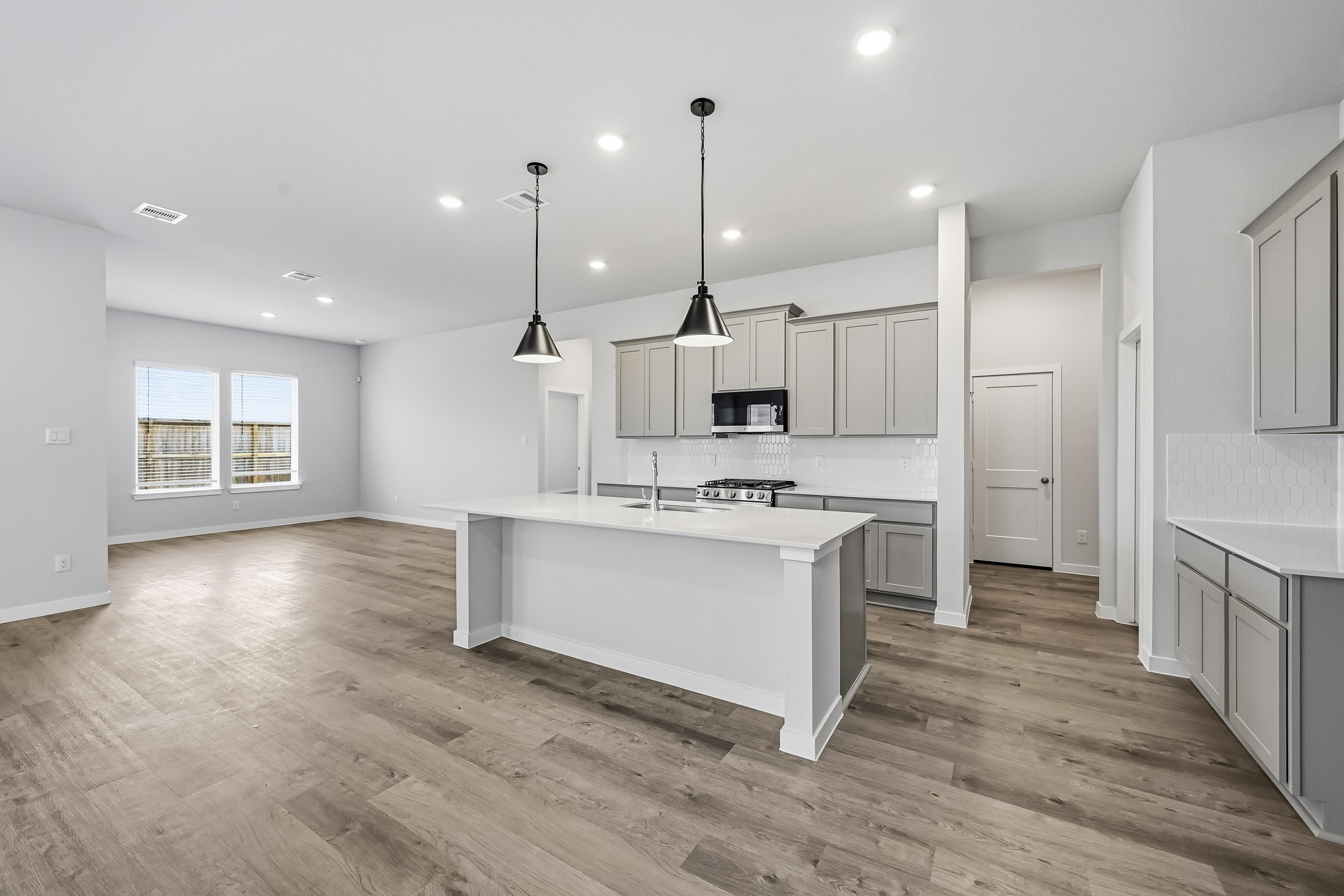 A kitchen with white cabinets.