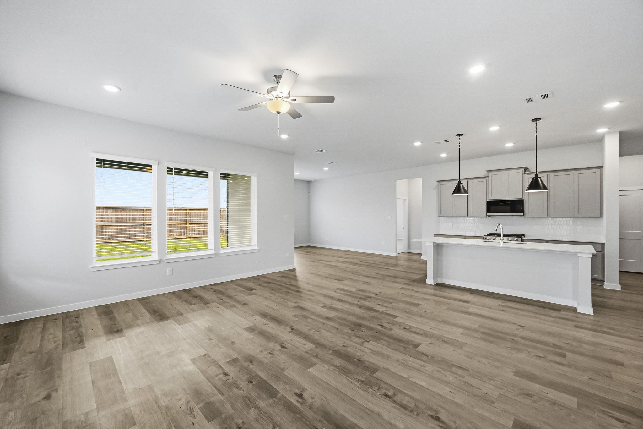 A large kitchen with a wood floor.