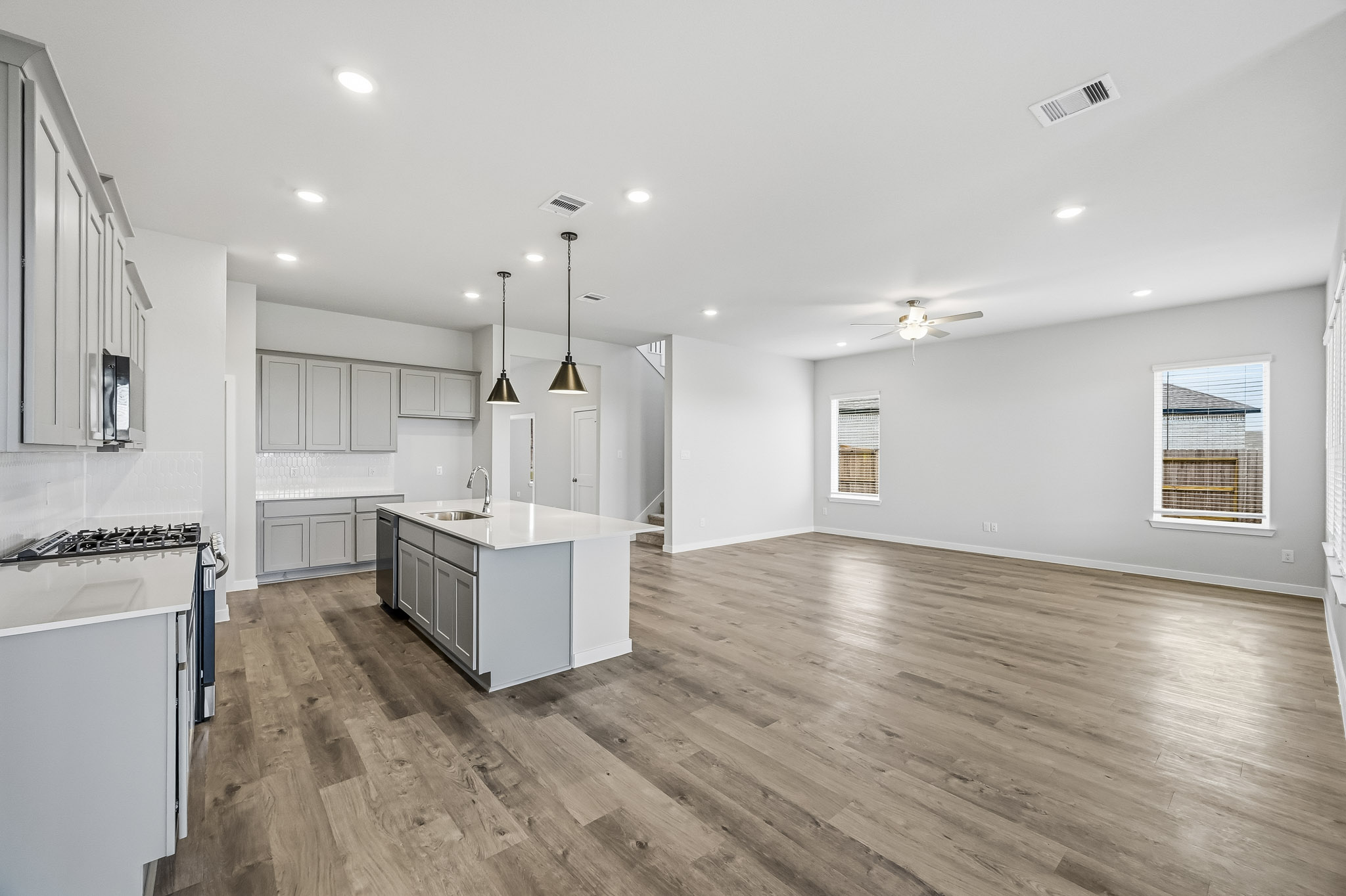 A kitchen with white cabinets.