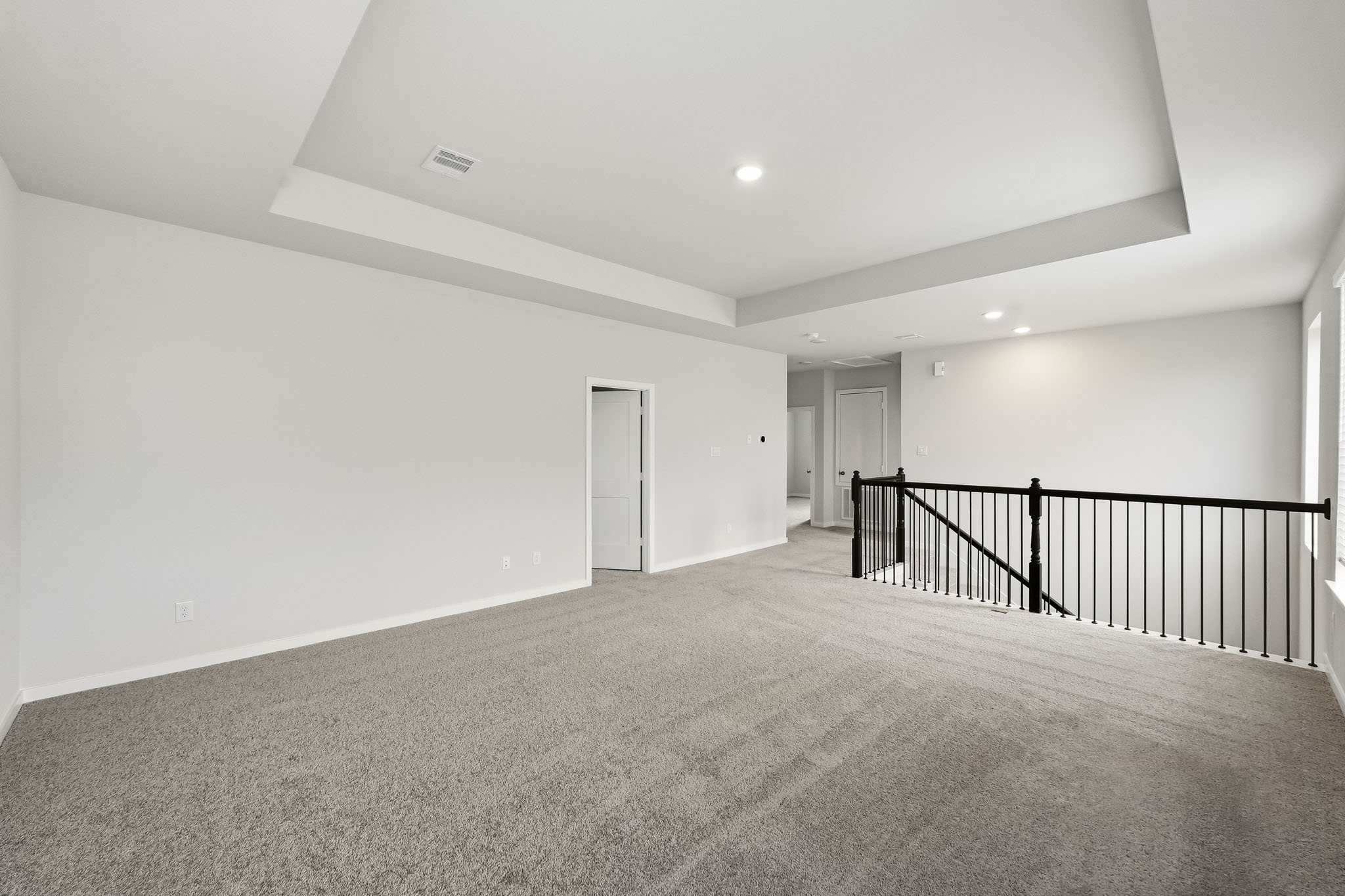 A hallway with a railing.
