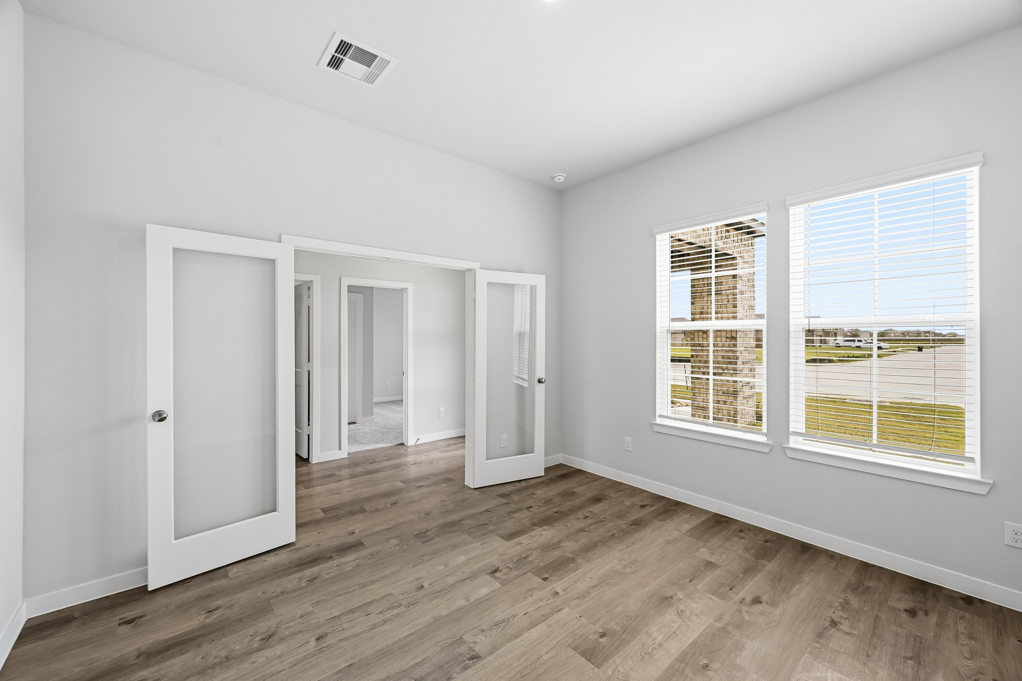 A room with white walls and a wood floor.
