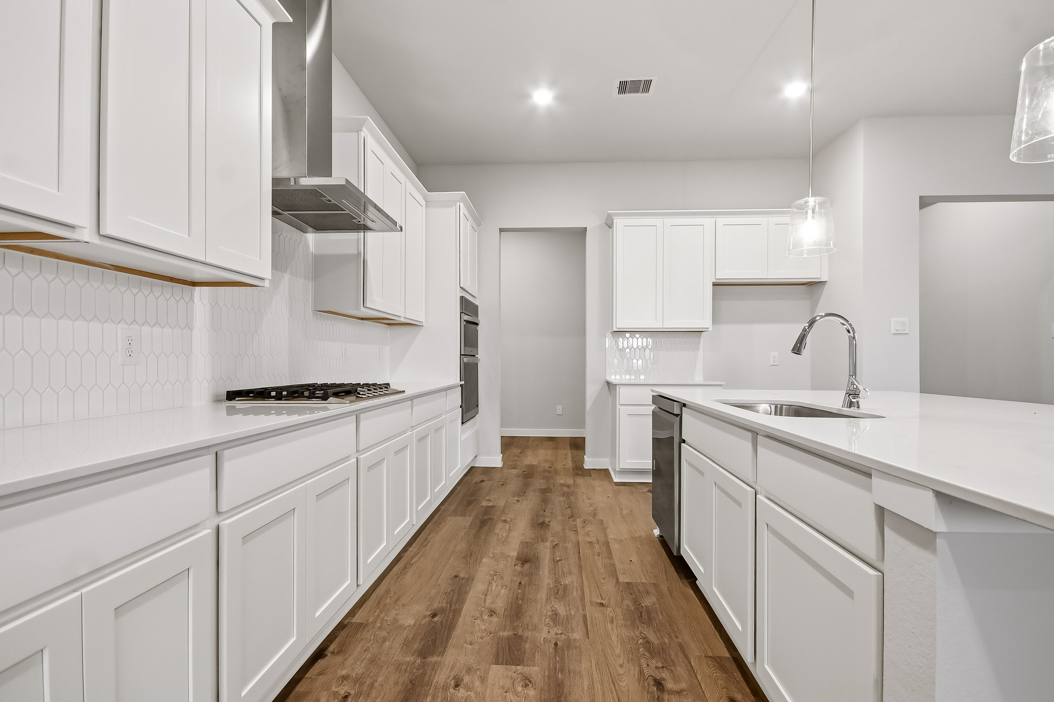 A kitchen with white cabinets.