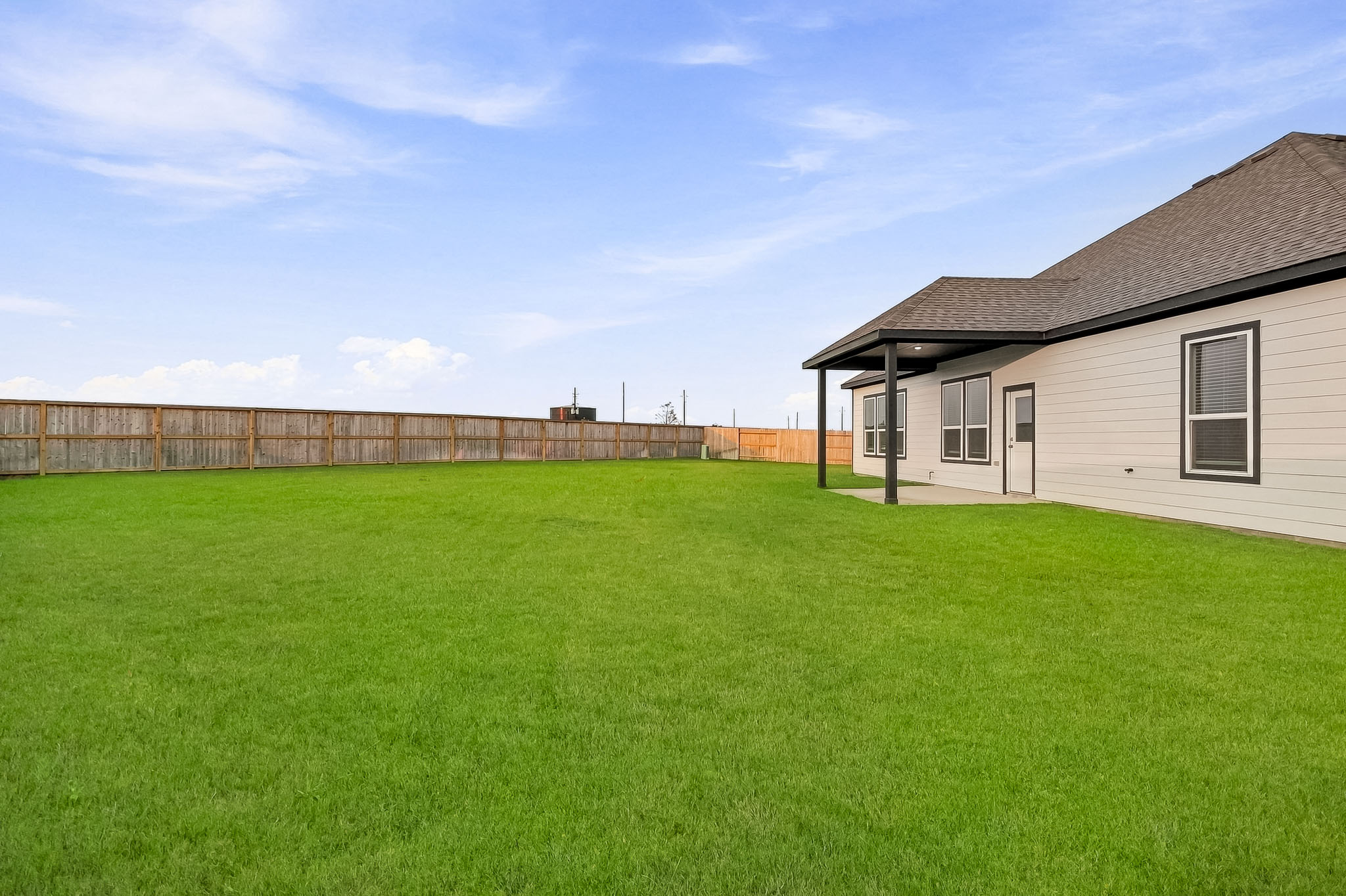 A house with a fence and grass.